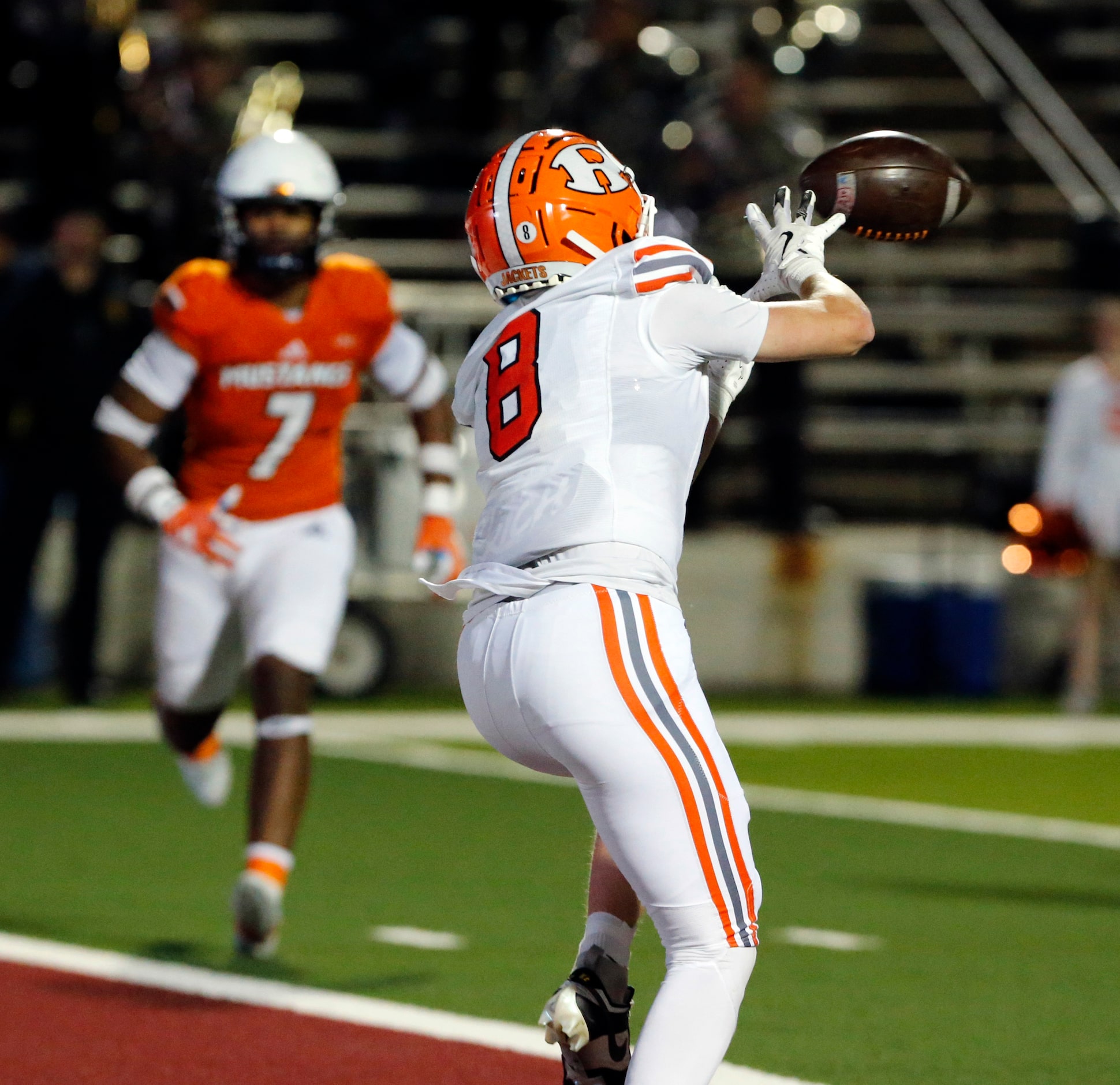 Rockwall High WR Triston Gooch (8) receives a touchdown pass during the first half of a high...