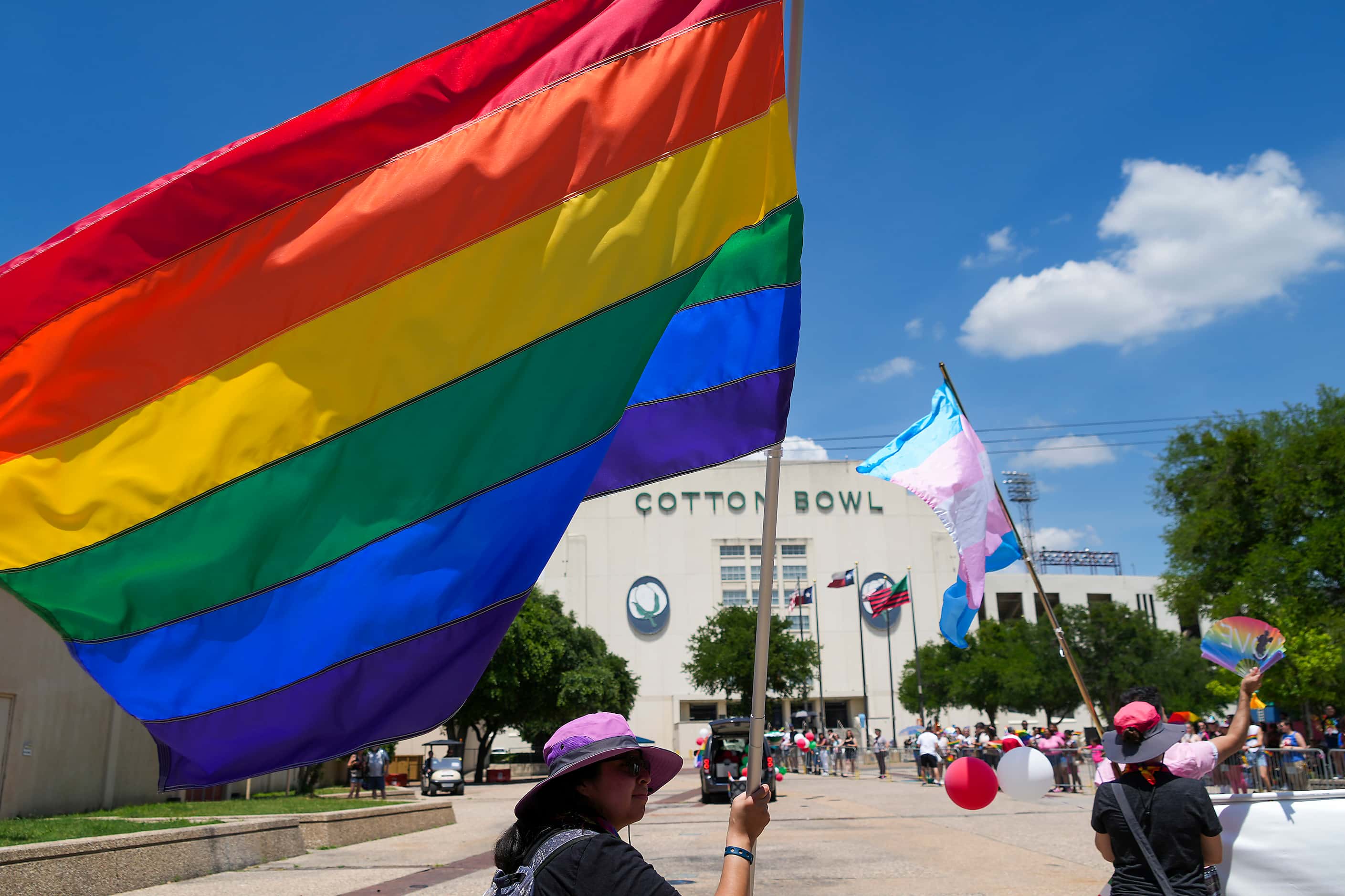 A participant waves a rainbow flag during the annual Alan Ross Texas Freedom Parade...