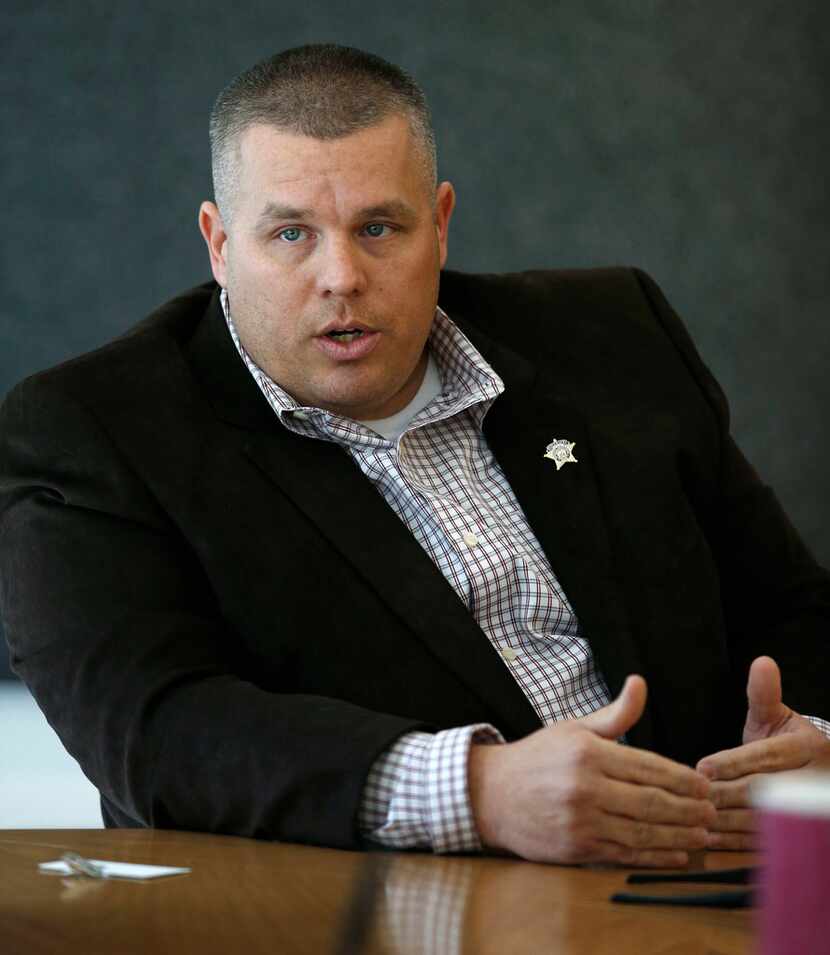 Aaron Meek, Republican candidate for sheriff, answers questions while meeting with the...