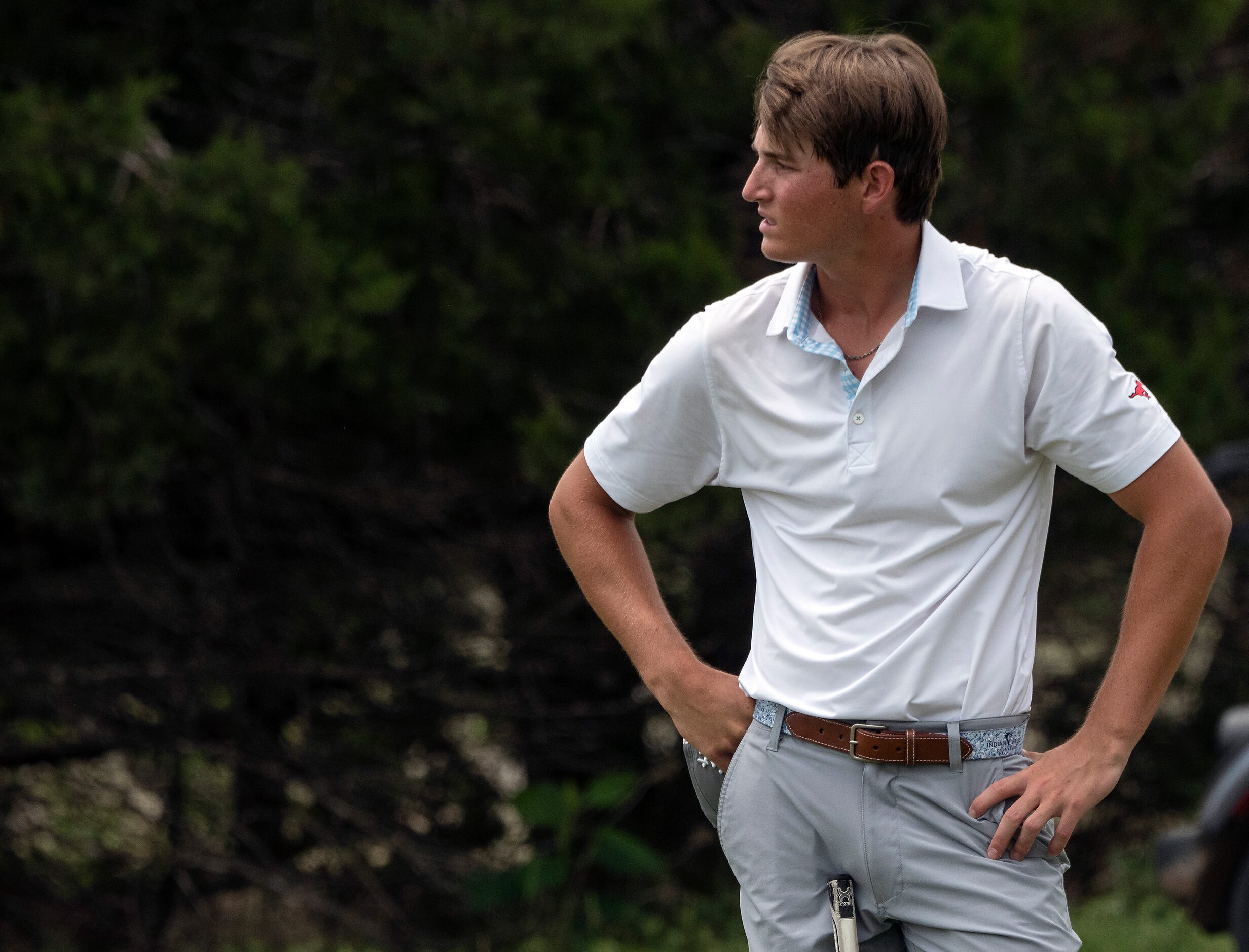 Richardson Pearce, Preston Stout, looks back out at the 18th hole after completing the final...