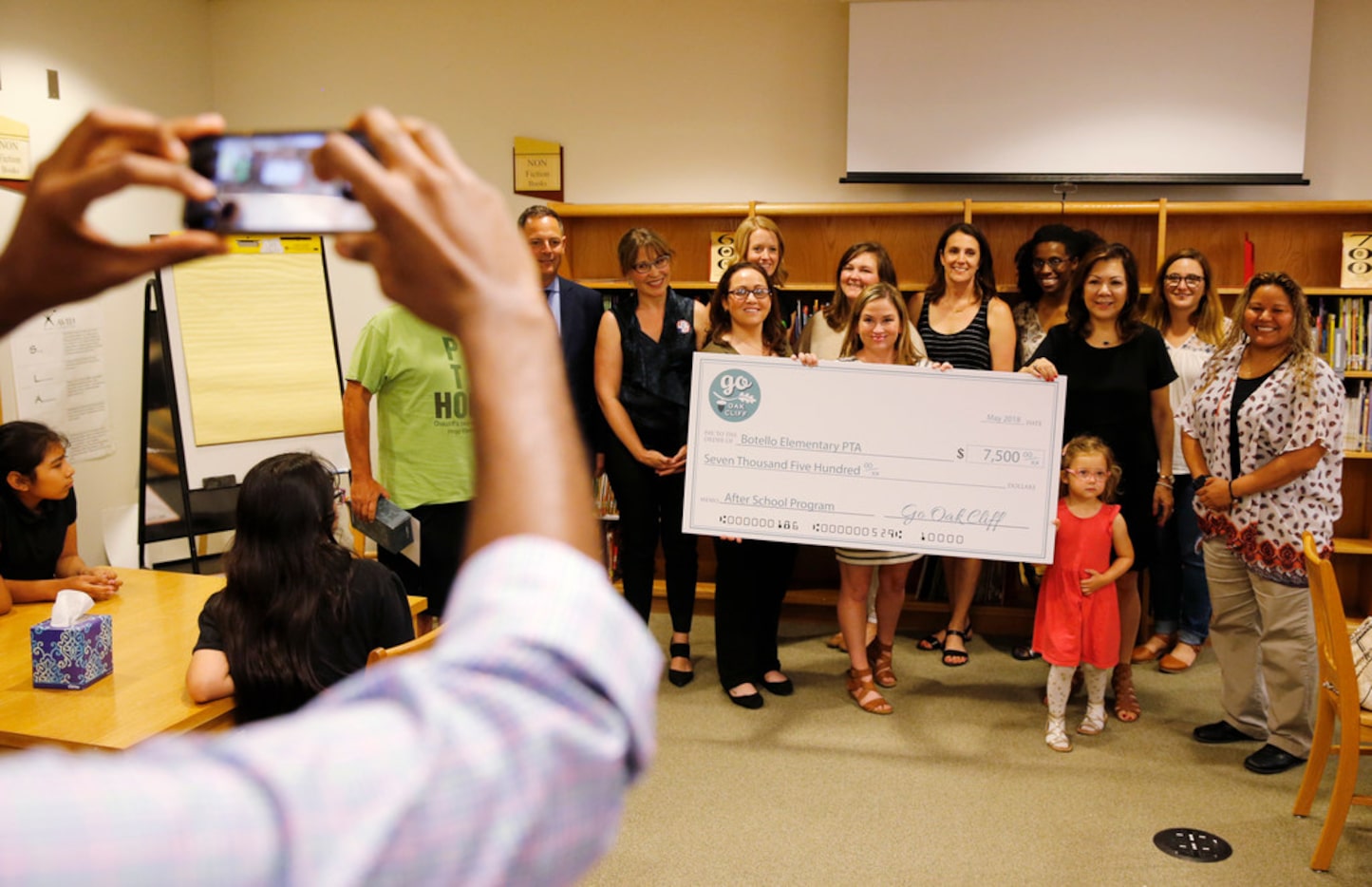 North Oak Cliff community leaders posed for a photo with Botello Elementary School principal...