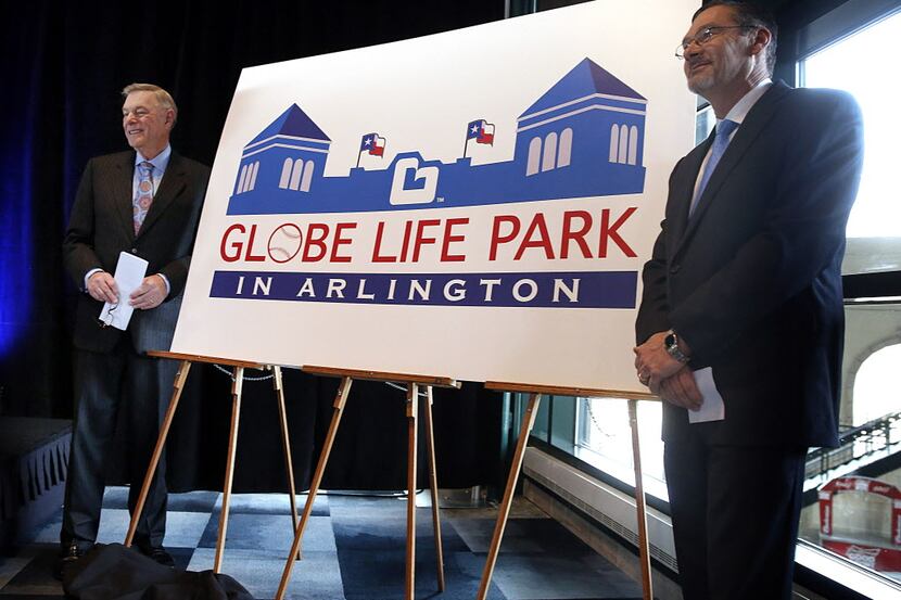 Globe Life Accident Insurance president Bill Leavell, right, shakes hands with Torchmark...