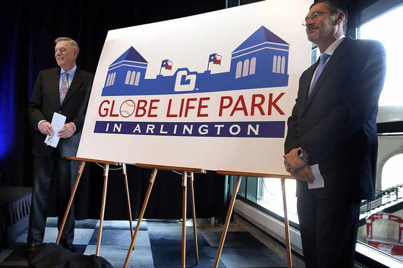 Globe Life Accident Insurance president Bill Leavell, right, shakes hands with Torchmark...
