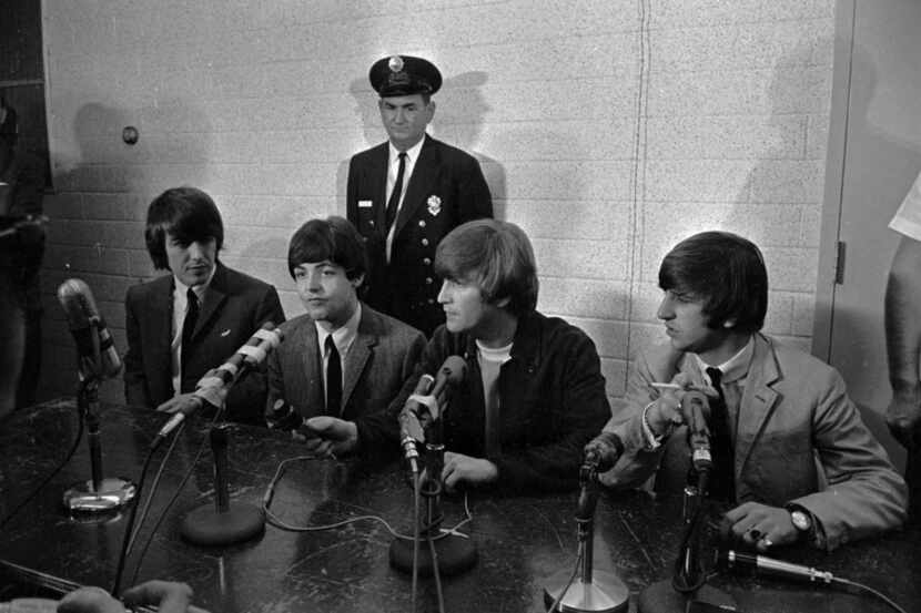 George Harrison (from left), Paul McCartney, John Lennon and Ringo Starr sat before a...