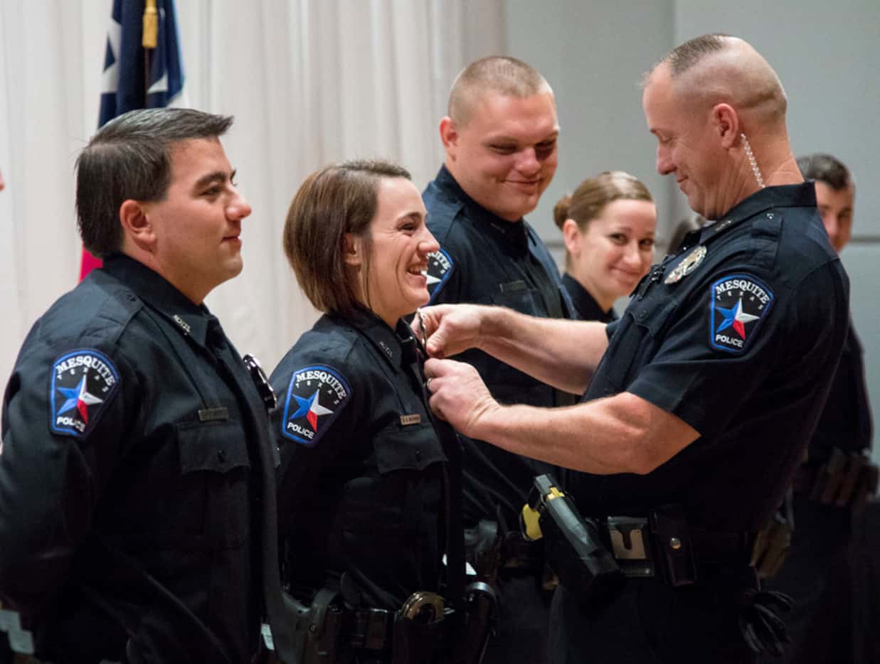 Officer Blythe Moehring of Oceanside, Calif., has her badge pinned by her father, Officer...