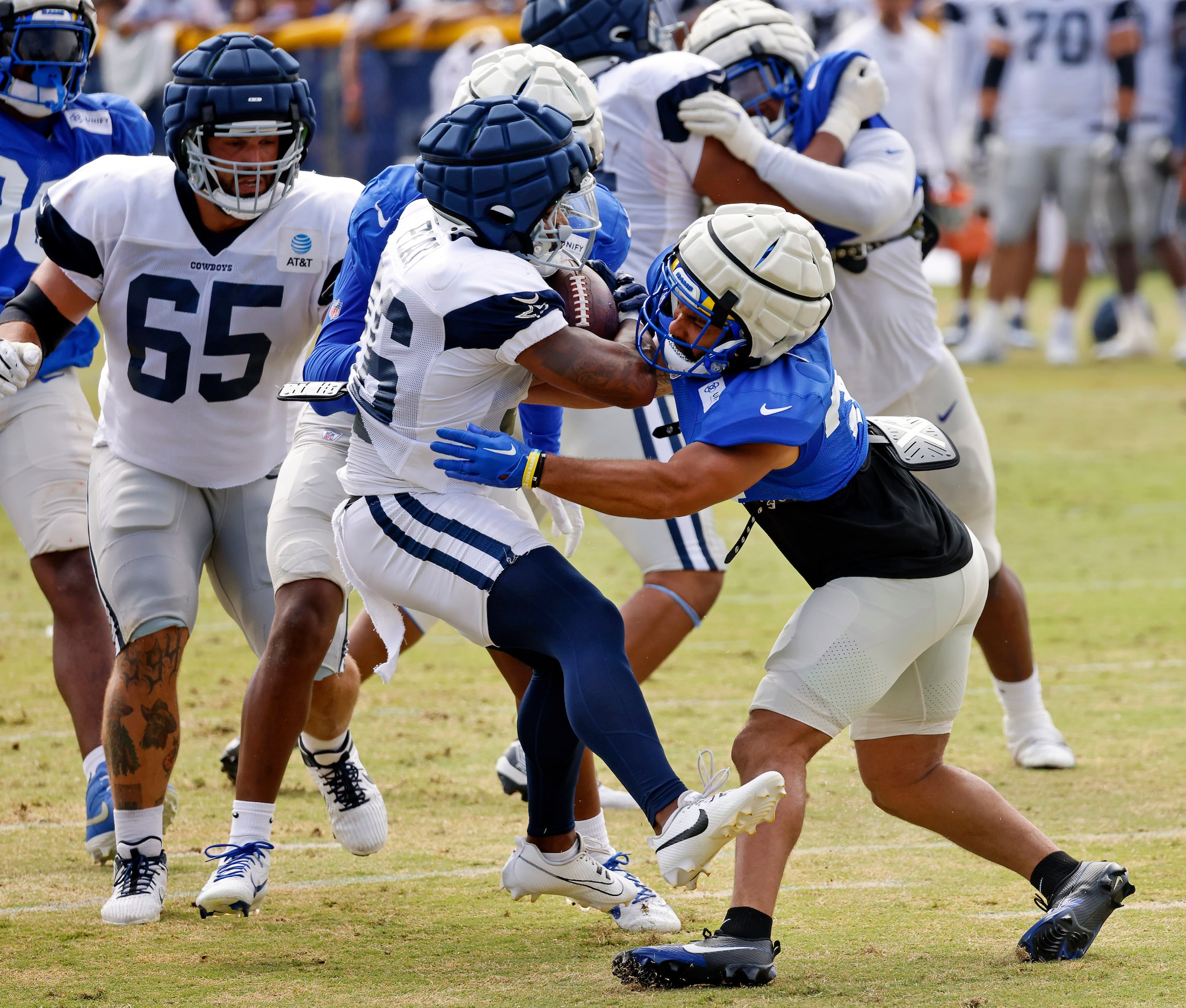 Dallas Cowboys running back Nathaniel Peat (36) is popped by Los Angeles Rams safety Tanner...