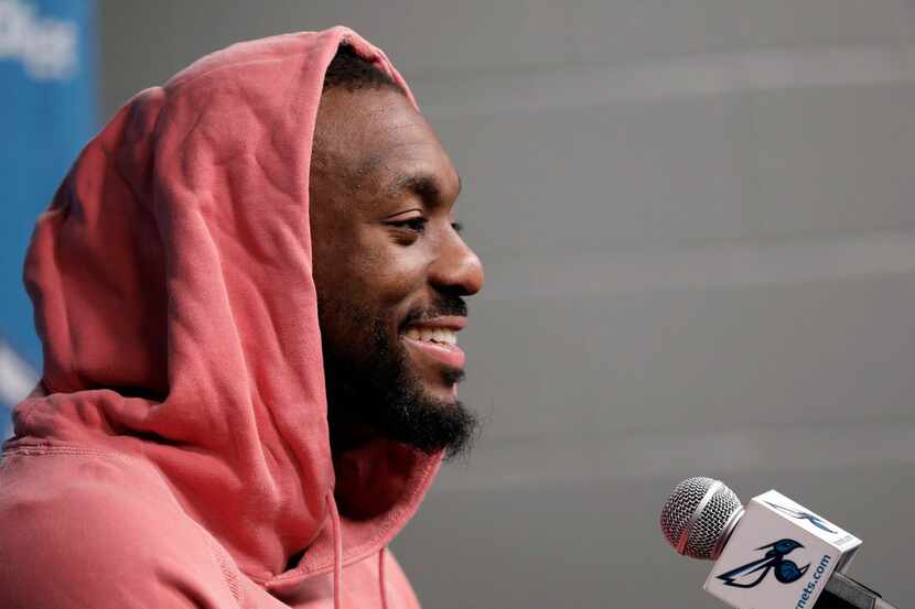 Charlotte Hornets' Kemba Walker smiles as he answers a question during end of season...