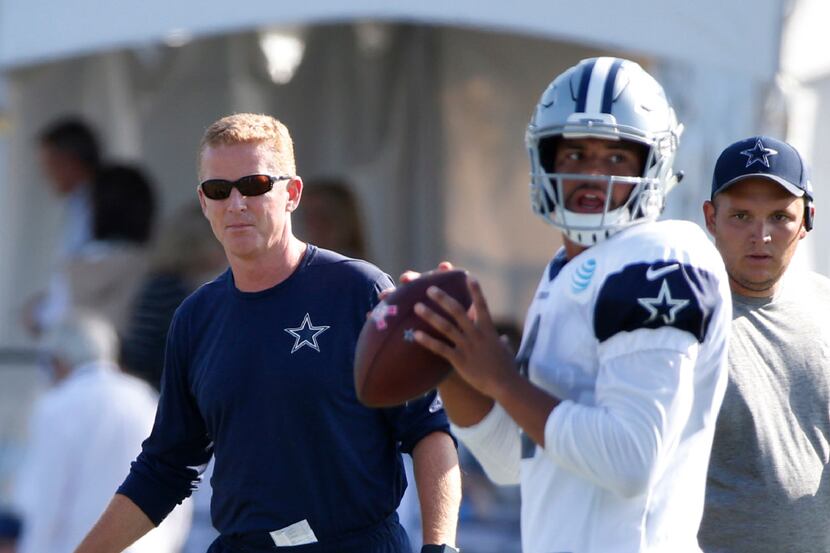 Dallas Cowboys head coach Jason Garrett watches as Dallas Cowboys quarterback Dak Prescott...