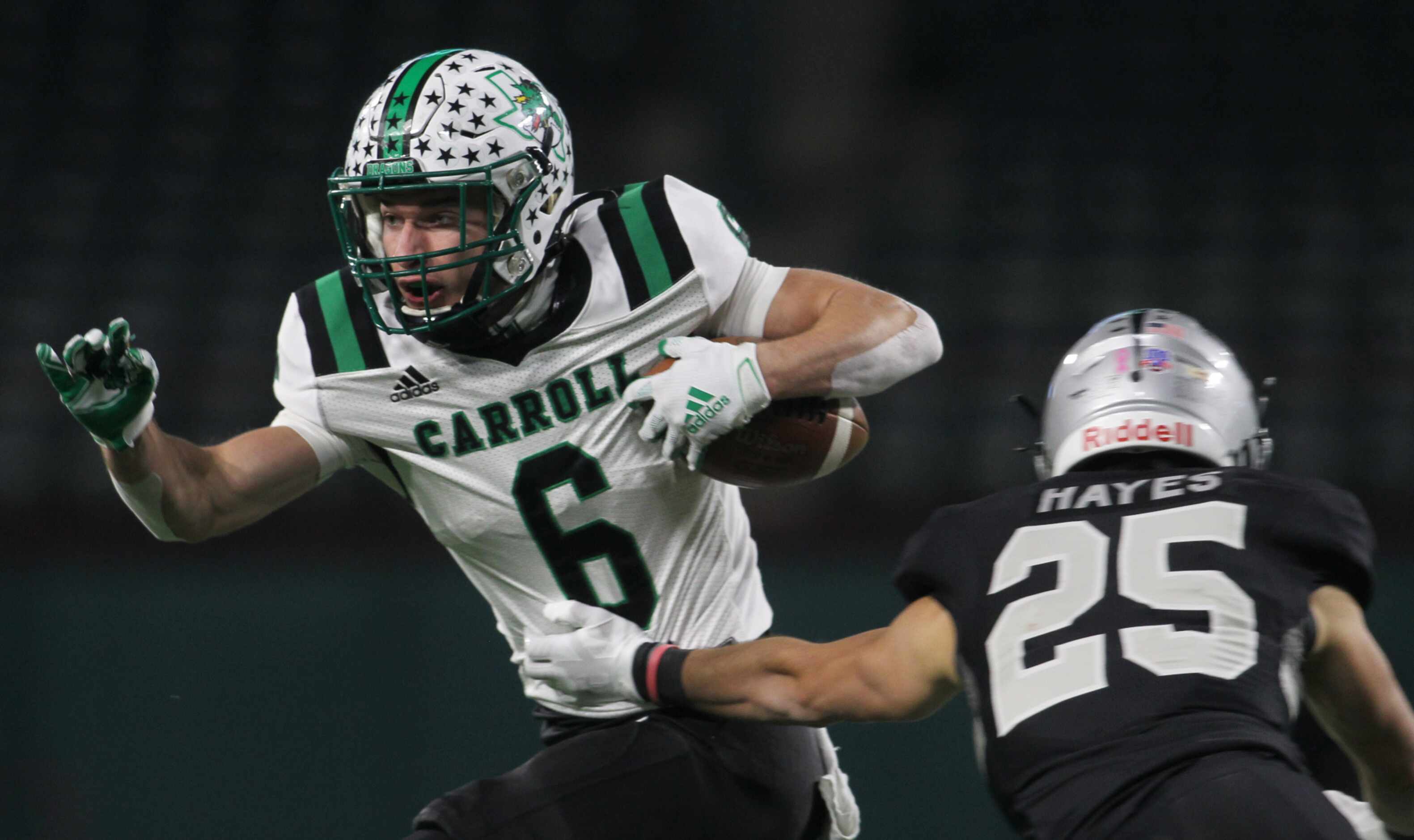 Southlake Carroll receiver Landon Samson (6) looks for running room after pulling in a first...