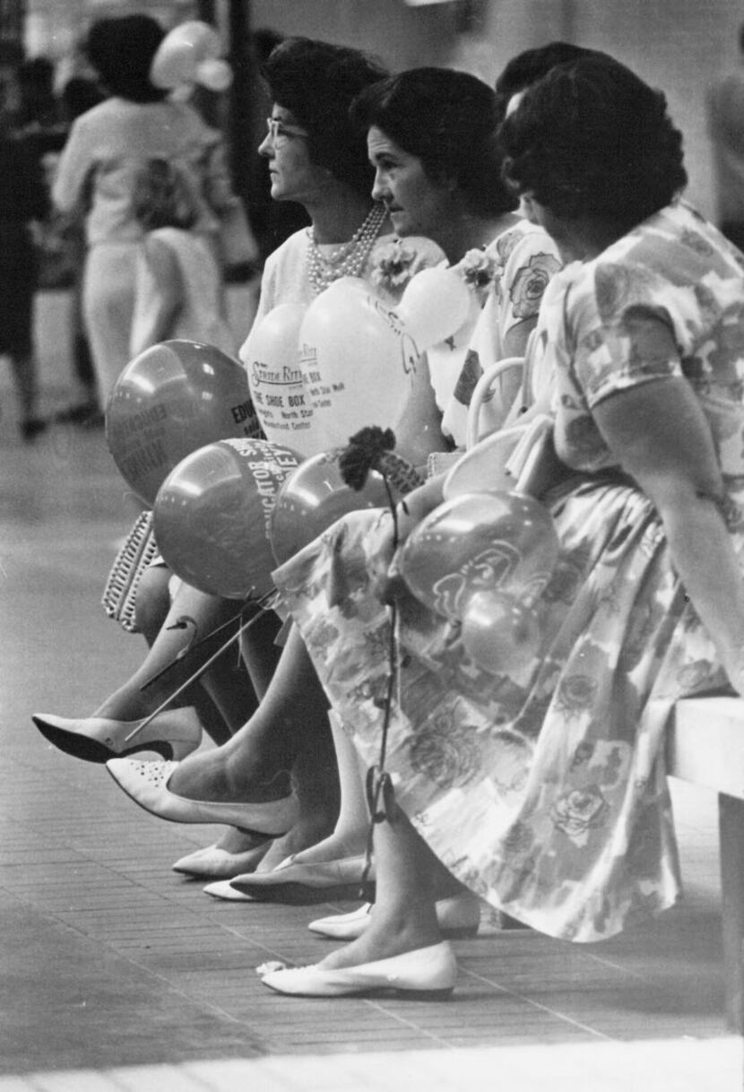 Women dressed up to come to NorthPark's opening on Aug. 19, 1965. They're holding balloons...