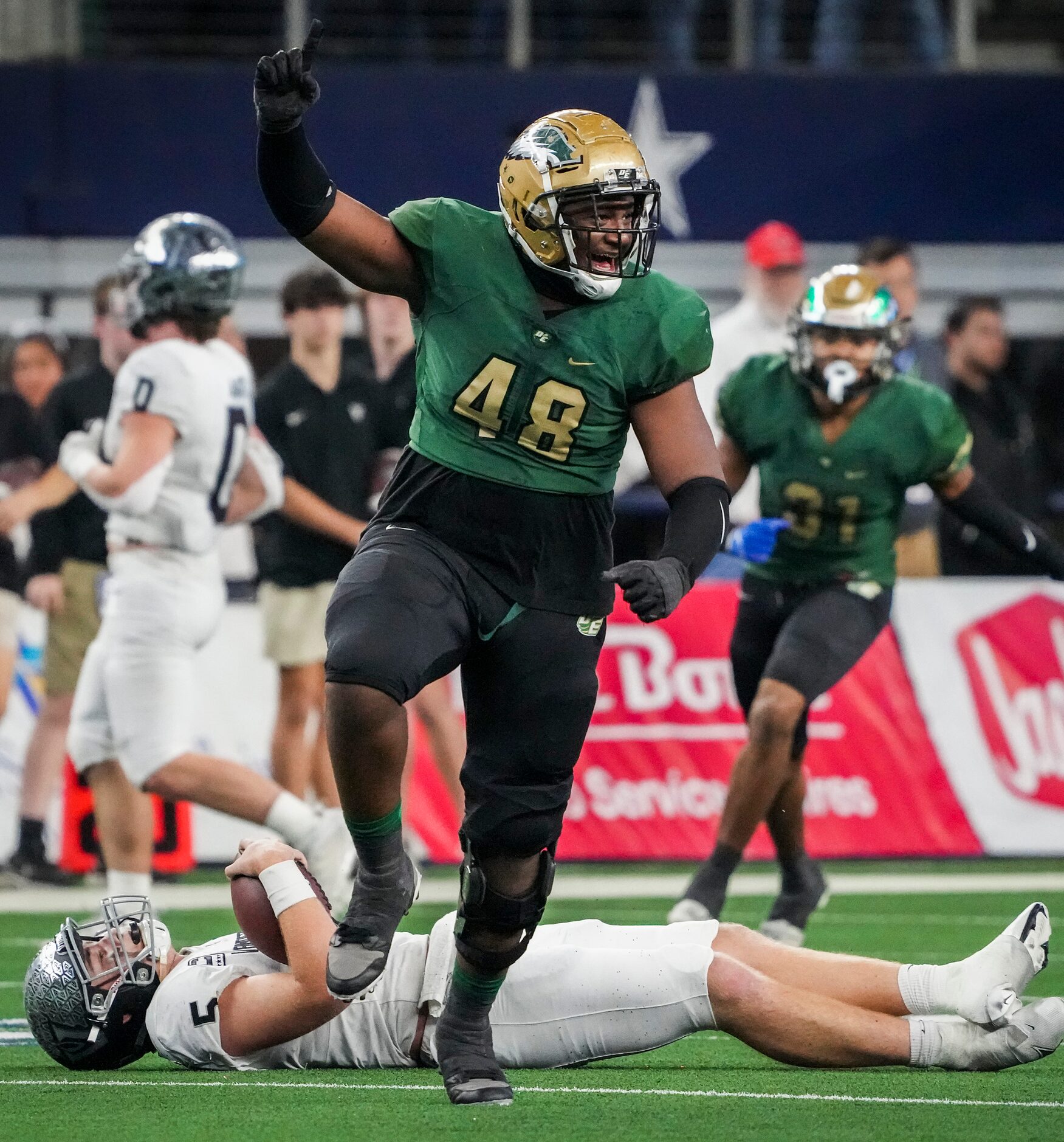 DeSoto defensive lineman Jason Douglas (48) celebrates after sacking Austin Vandegrift...