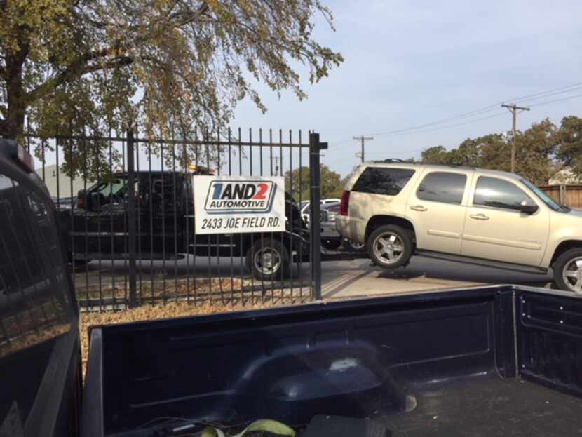 A car is towed into 1and2 Automotive, a common sight at the "Buy here, pay here" auto dealer...
