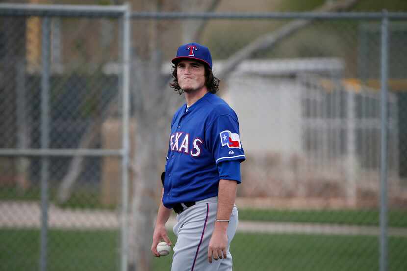 Texas Rangers pitcher Luke Jackson reacts after a pitching session during a workout at the...