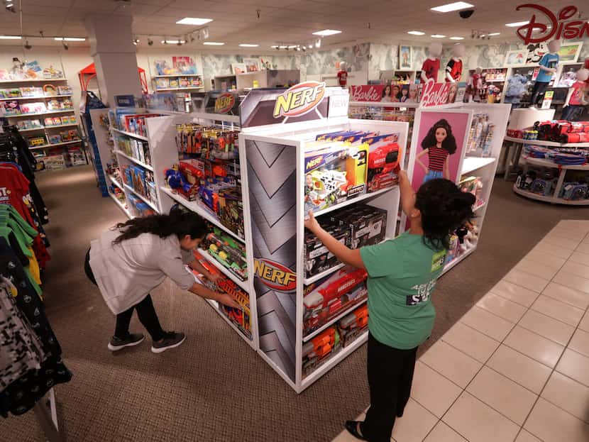 Employees straighten up the toy section at the Collin Creek Mall J.C. Penney in Plano.