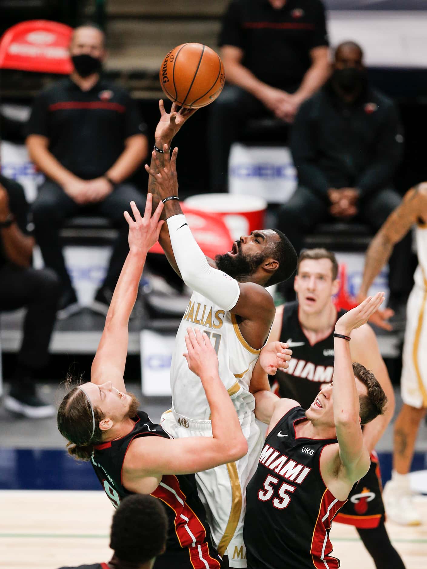 Dallas Mavericks guard Tim Hardaway Jr. (11) attempts a shot as Miami Heat forwards Kelly...