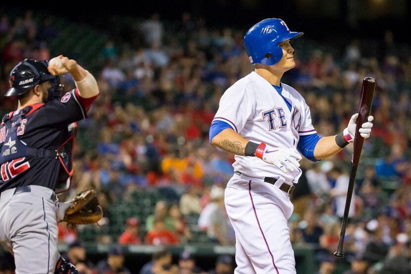 Texas Rangers right fielder Shin-Soo Choo heads back to the dugout after striking out during...