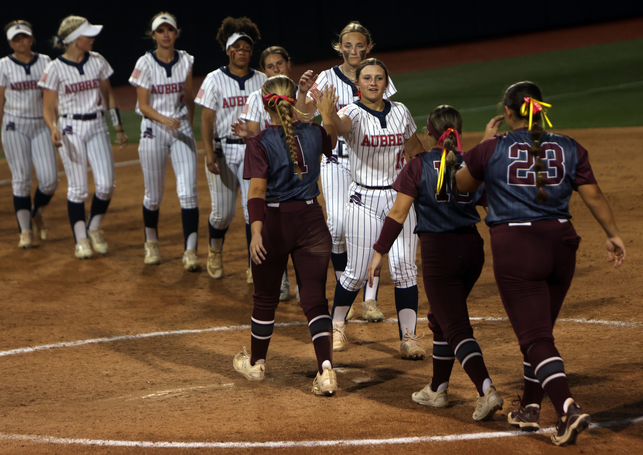 Aubrey players, left, shake hands with Corpus Christi Calallen players after losing 5-1. The...