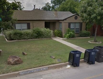 "2700 Forest Park Blvd" is written on the curb in front of the house, which has a different...