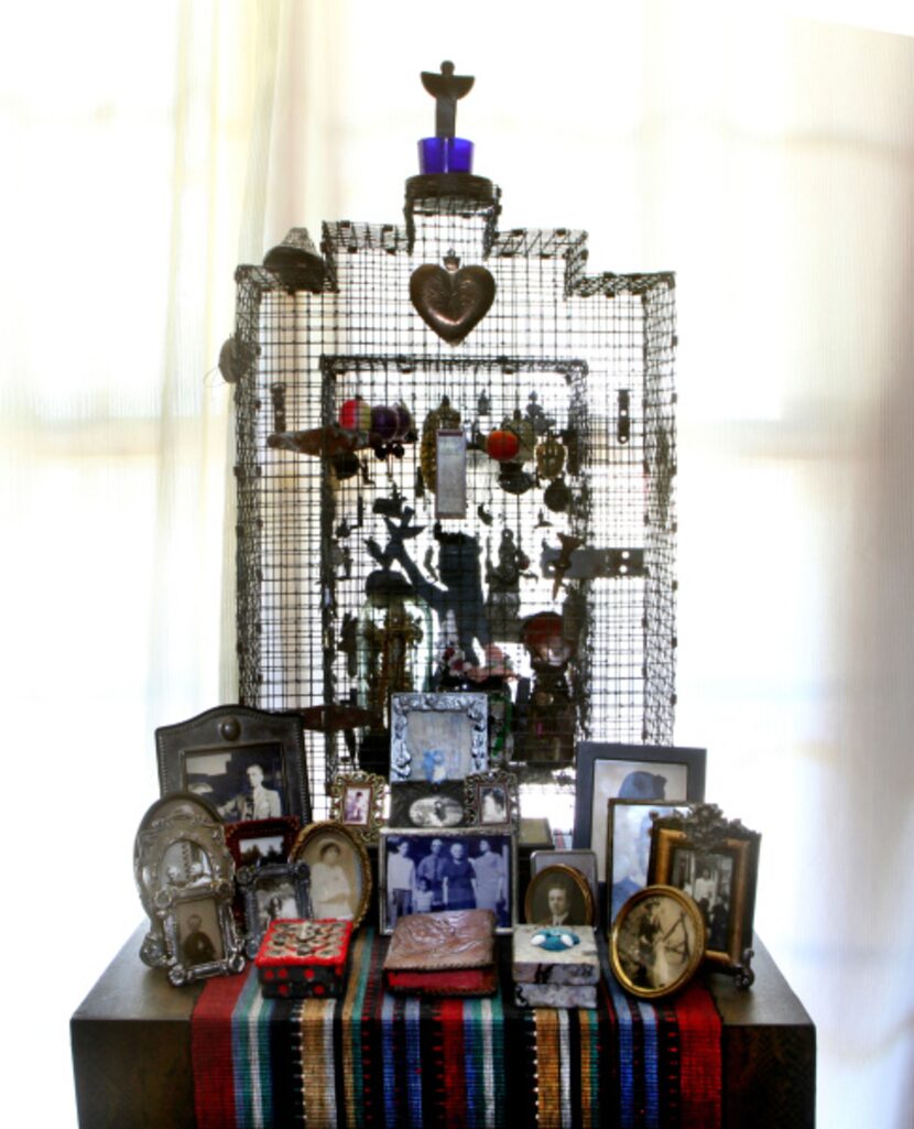 Wire shrine with milagros, c. 1990, with family pictures in the living room at the home of...