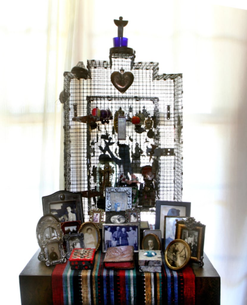 Wire shrine with milagros, c. 1990, with family pictures in the living room at the home of...