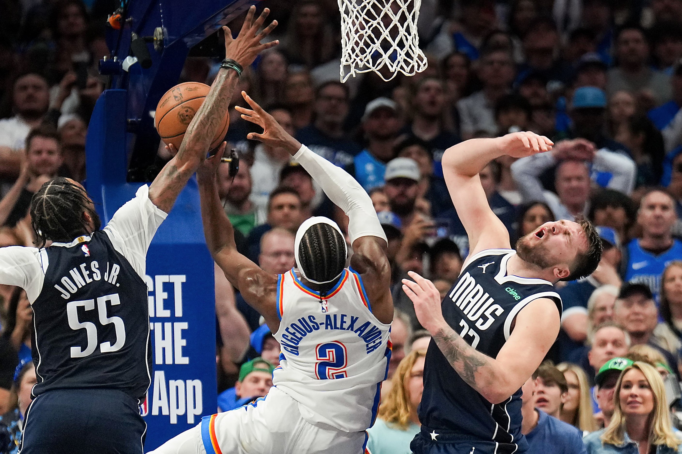 Dallas Mavericks guard Luka Doncic (77) draws a charge on a drive to the basket by Oklahoma...