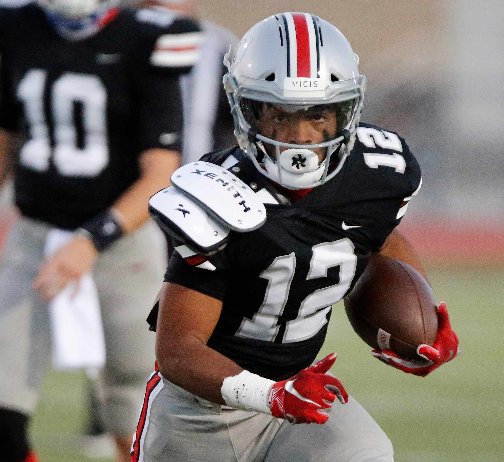 Lovejoy High School running back Noah Naidoo (12) carries the football during the first half...