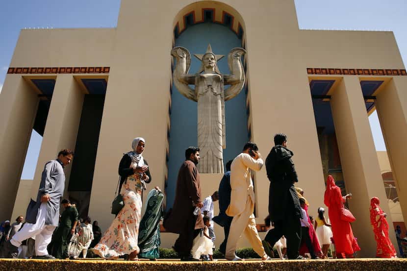 Muslims leave the Centennial Building at Fair Park after gathering for prayer during Eid...