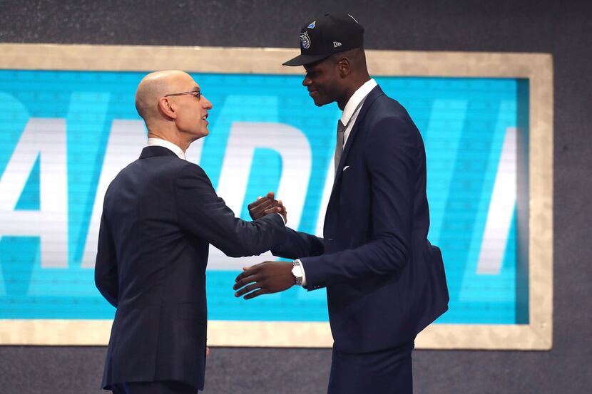 NEW YORK, NY - JUNE 21:  Mohamed Bamba poses with NBA Commissioner Adam Silver after being...