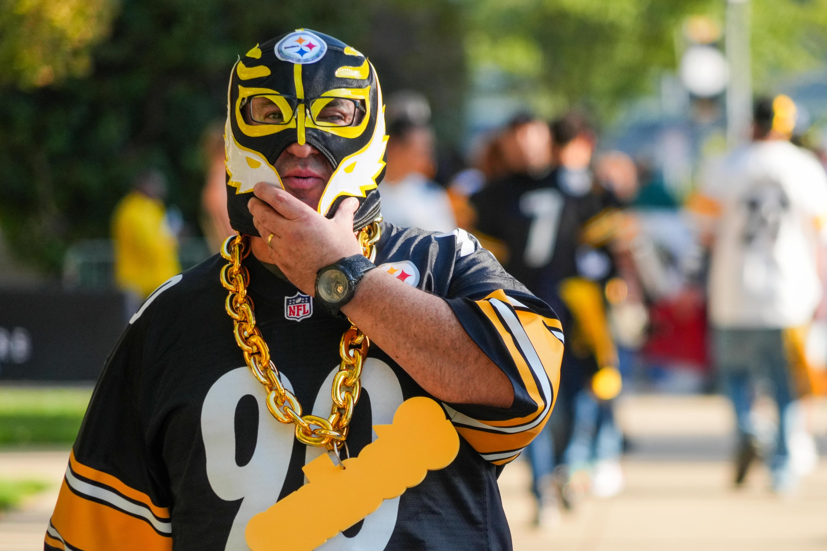 Pittsburgh Steelers fans head to the stadium before an NFL football game against the Dallas...