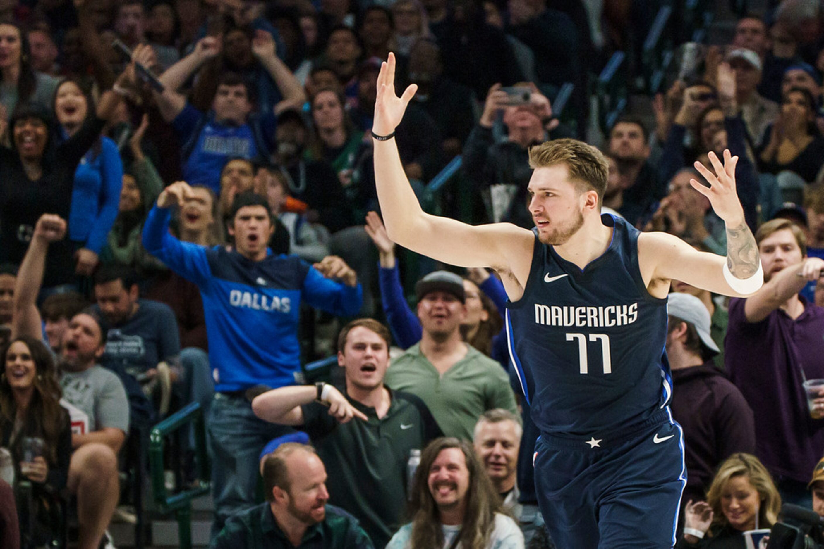 Dallas Mavericks guard Luka Doncic celebrates after making a shot during the second half of...