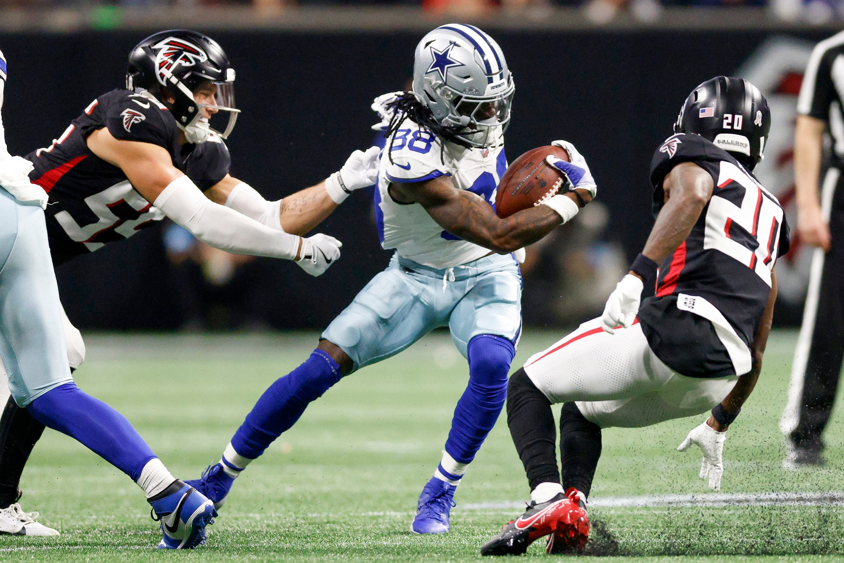 Atlanta Falcons linebacker Kaden Elliss (55) grabs the jersey of Dallas Cowboys wide...