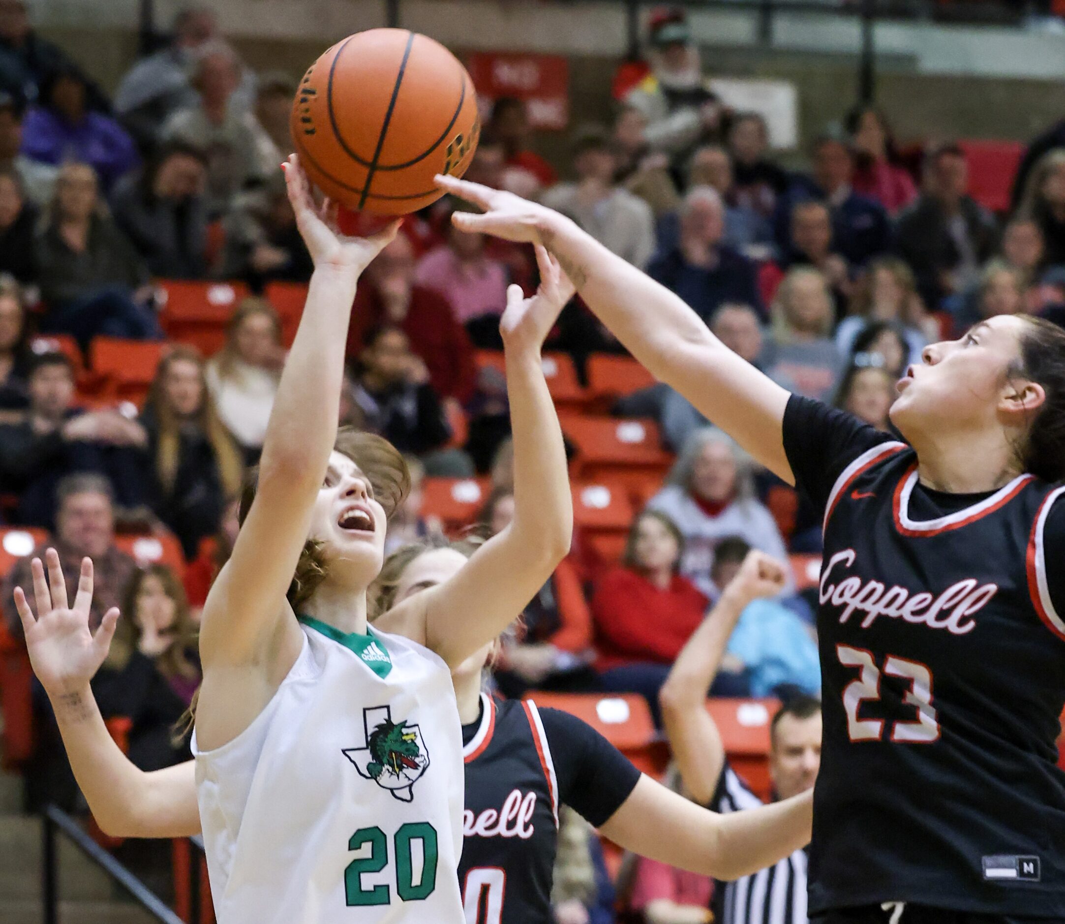 Southlake Carroll senior guard Camryn Tade (20) is blocked from a shot on the net by Coppell...