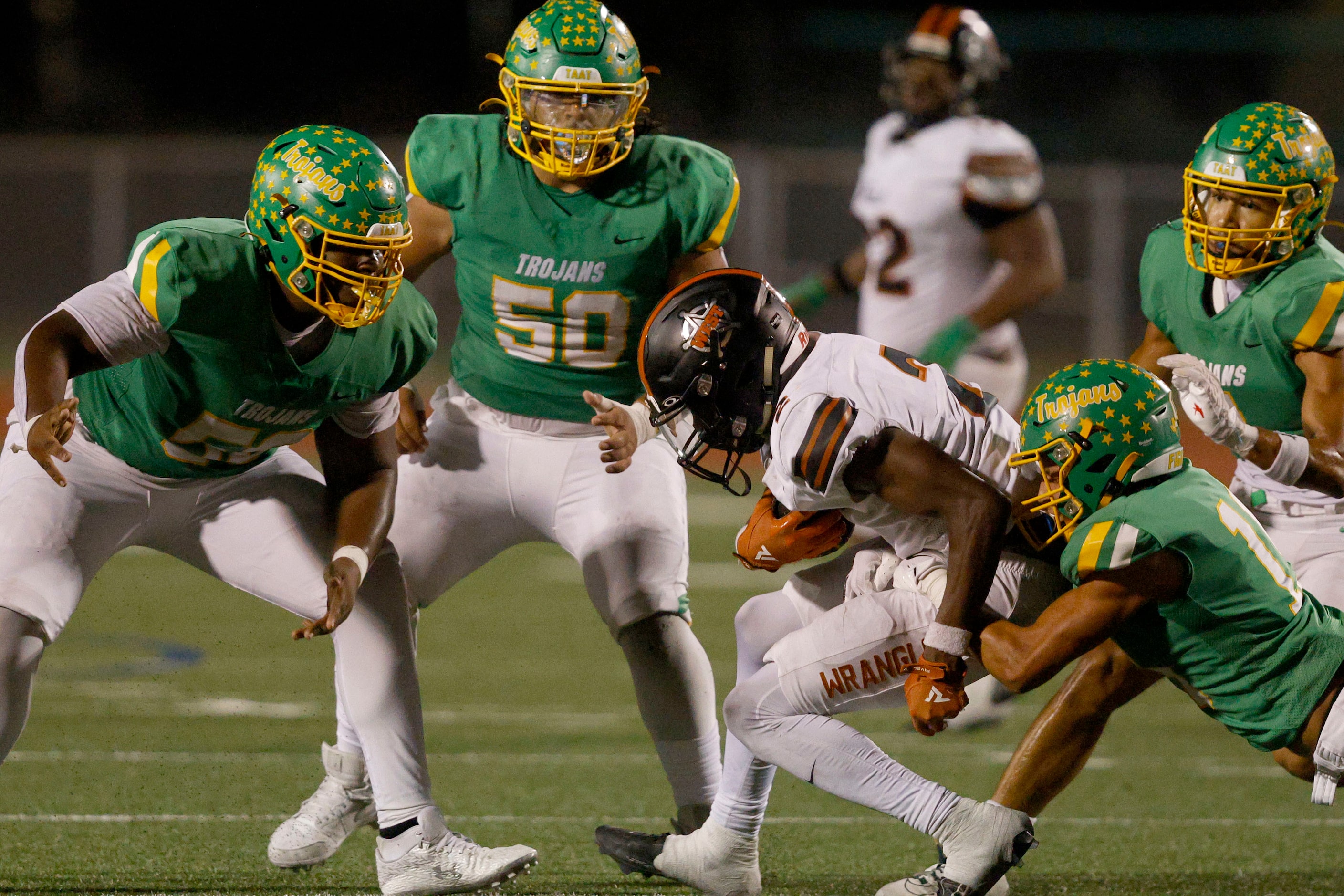 Newman Smith defense players go to stop West Mesquite's Greg Gipson (2) in the first half of...