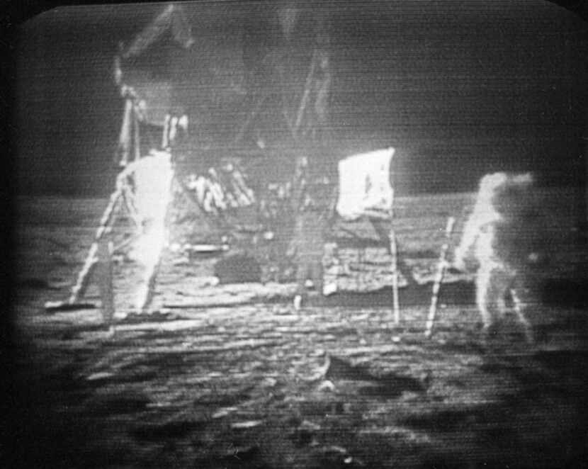 TV monitors showed Apollo 11 astronaut Neil Armstrong (right) trudging across the surface of...