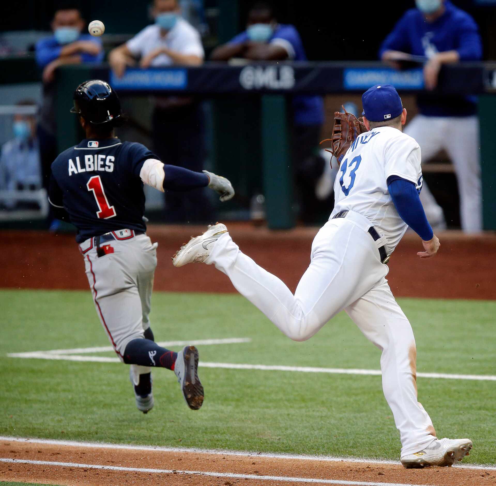 Los Angeles Dodgers first baseman Max Muncy (13) attempts to tag Atlanta Braves batter Ozzie...