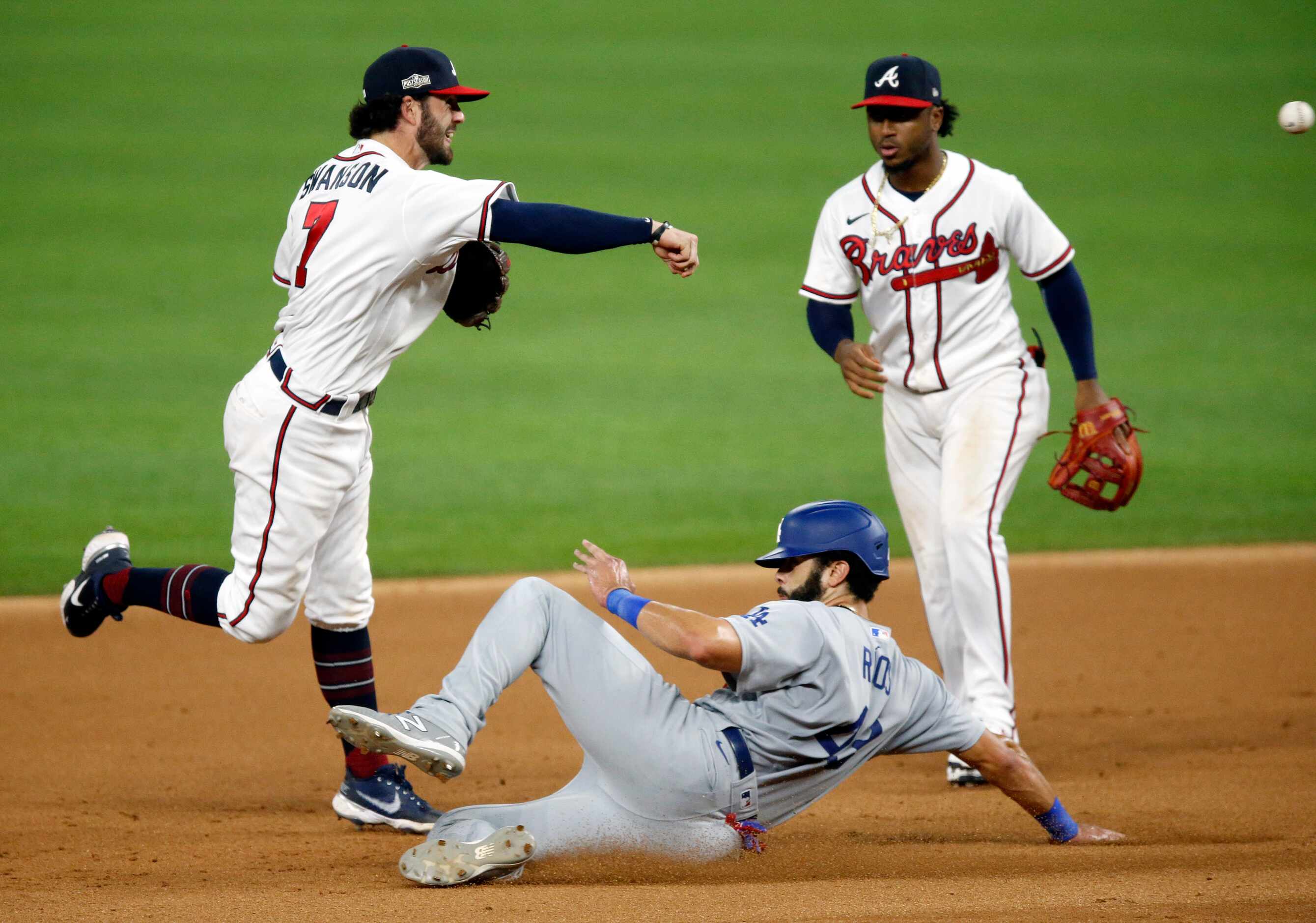 Atlanta Braves shortstop Dansby Swanson (7) turns the front end of a double play attempt as...