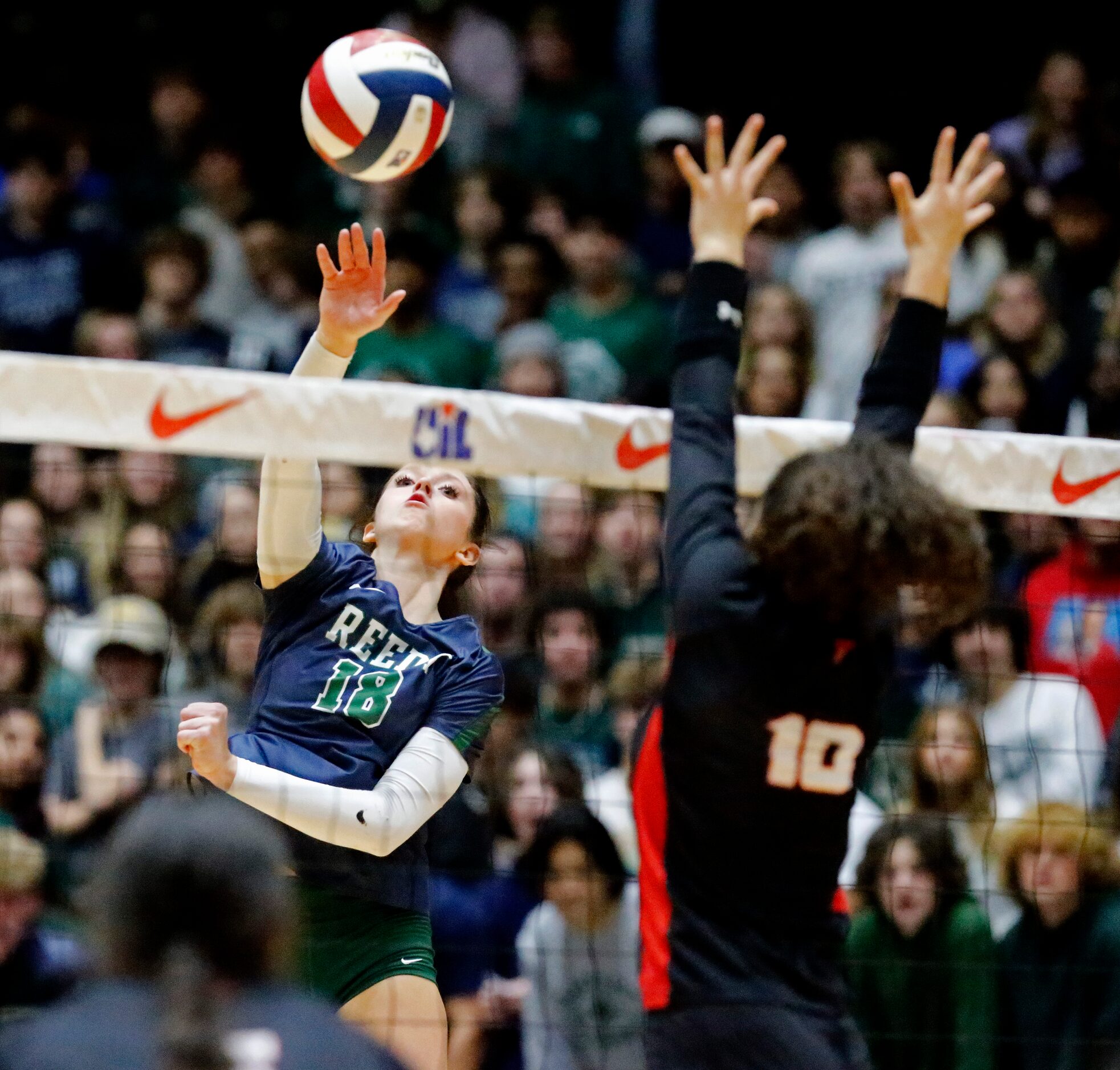 Reedy High School's Halle Schroder (18) gets a hit while Colleyville Heritage High School's...