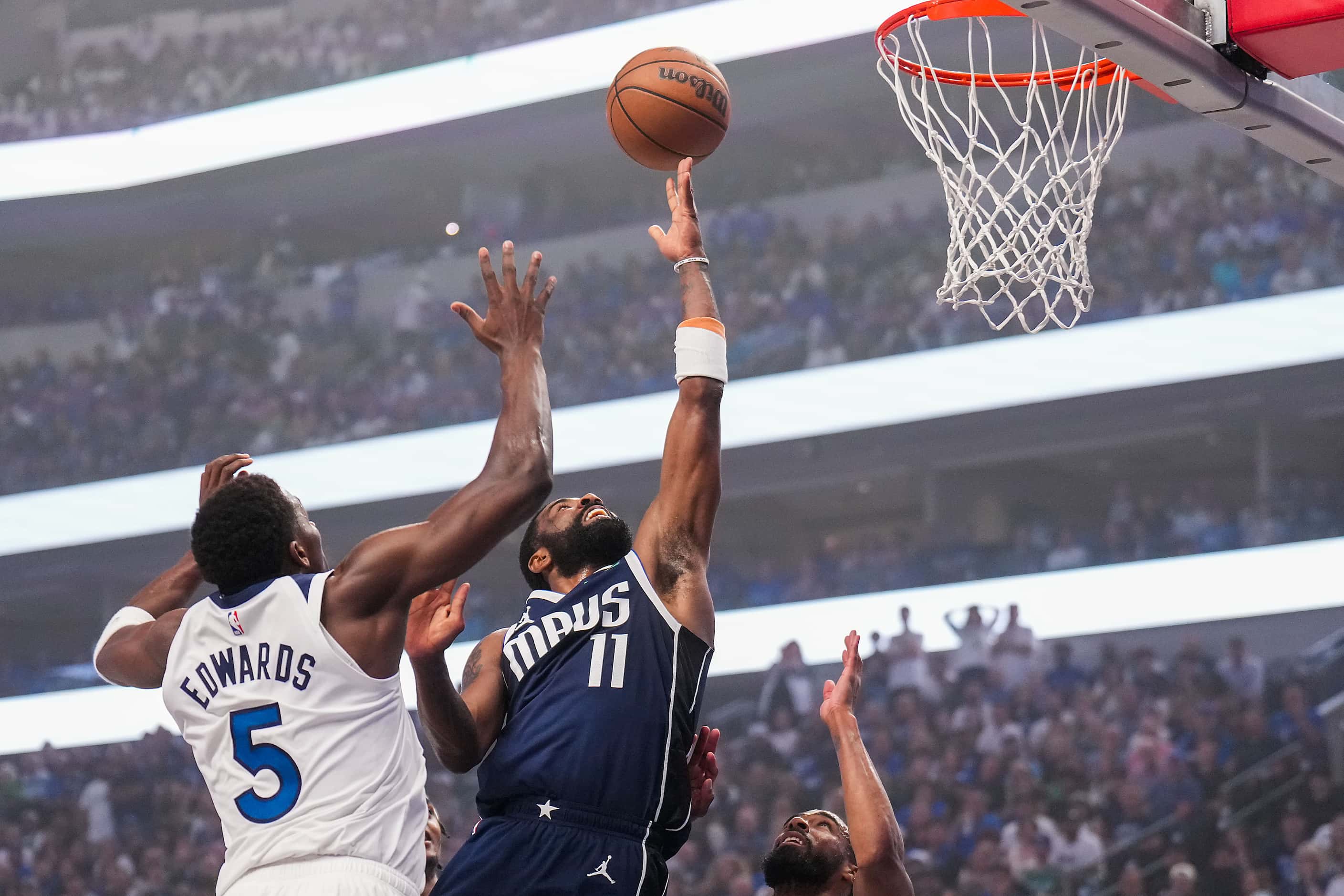 Dallas Mavericks guard Kyrie Irving (11) shoots past Minnesota Timberwolves guard Anthony...