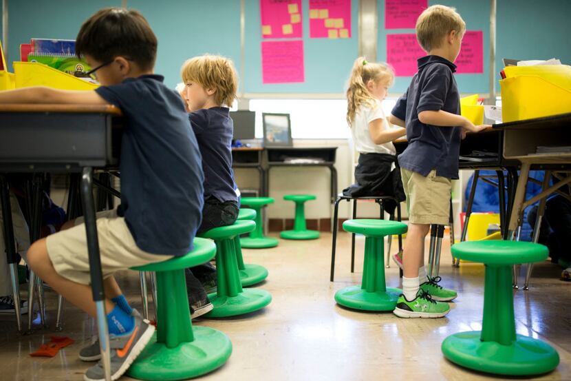 Students sit on wobble stools during second-grade reading class at Hexter Elementary in...