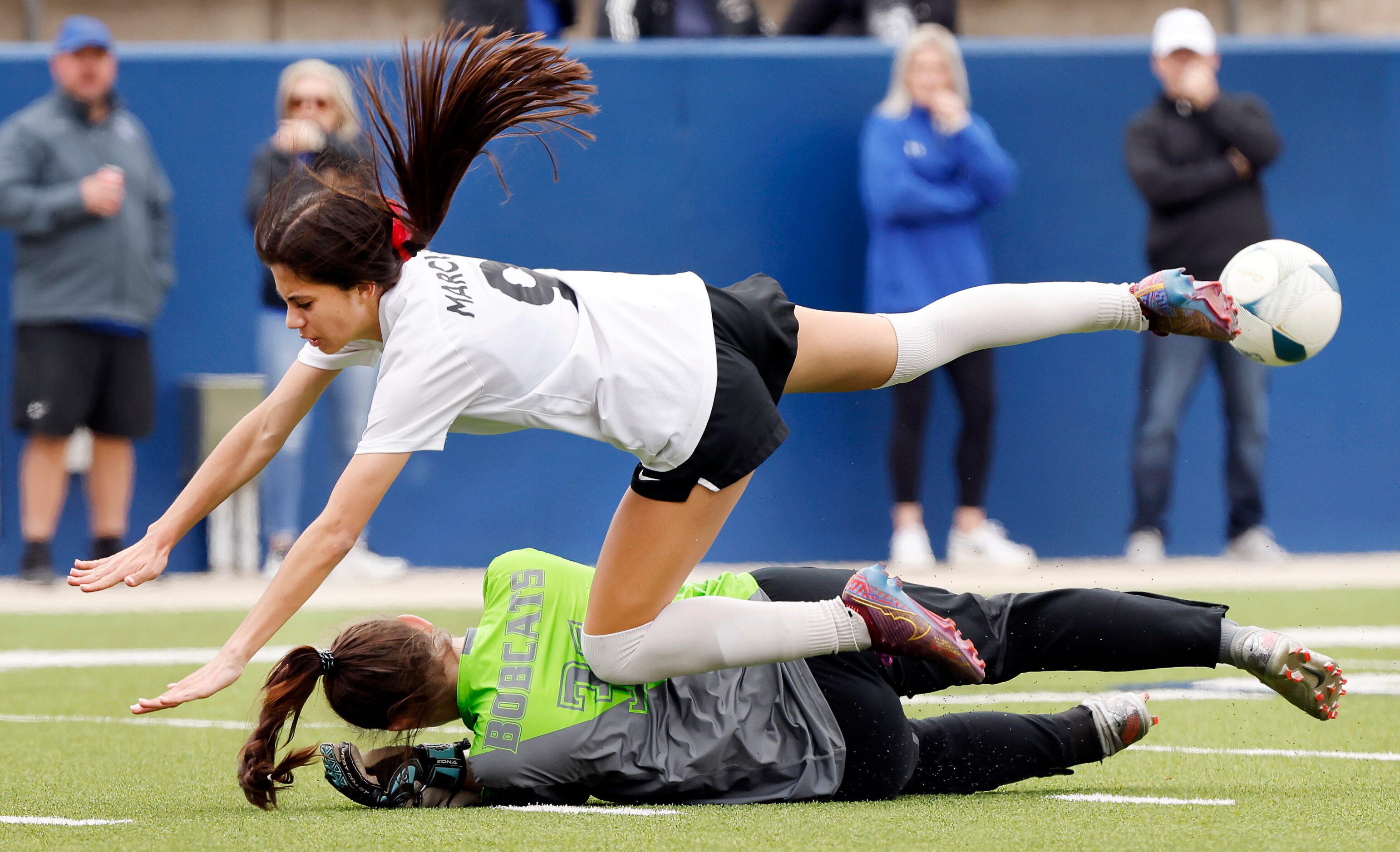 Flower Mound Marcus forward Maddie Hayes (9) collides with Trophy Club Byron Nelson goal...