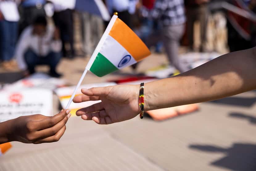 The national flag of India is passed out at Saturday's demonstration.