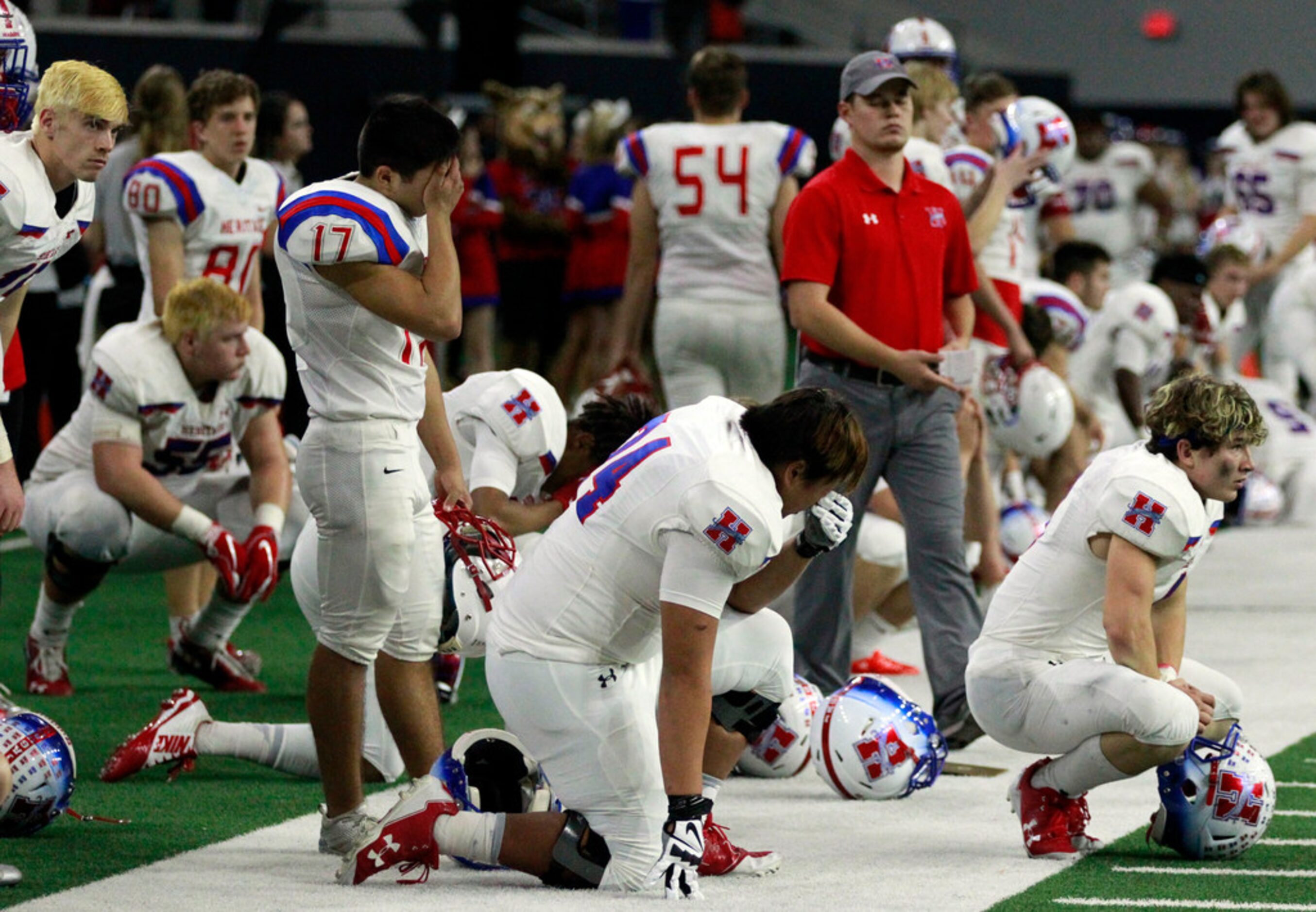 The Midlothian Heritage Jaguars mourn their loss to Carthage in overtime on the bench during...