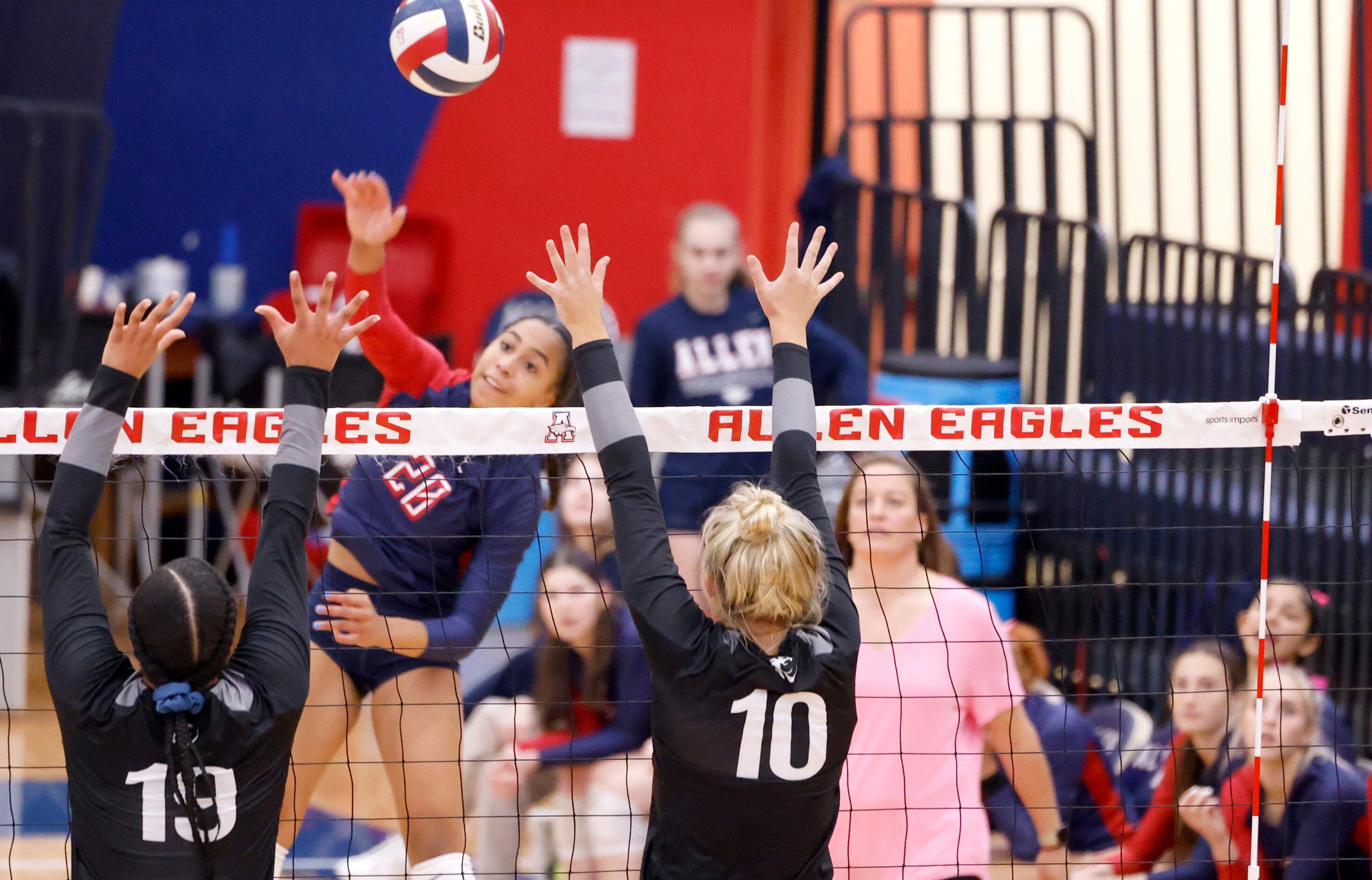 Allen freshman Kennedy Crayton (20) spikes the ball into Denton Guyer sophomore Sydney...