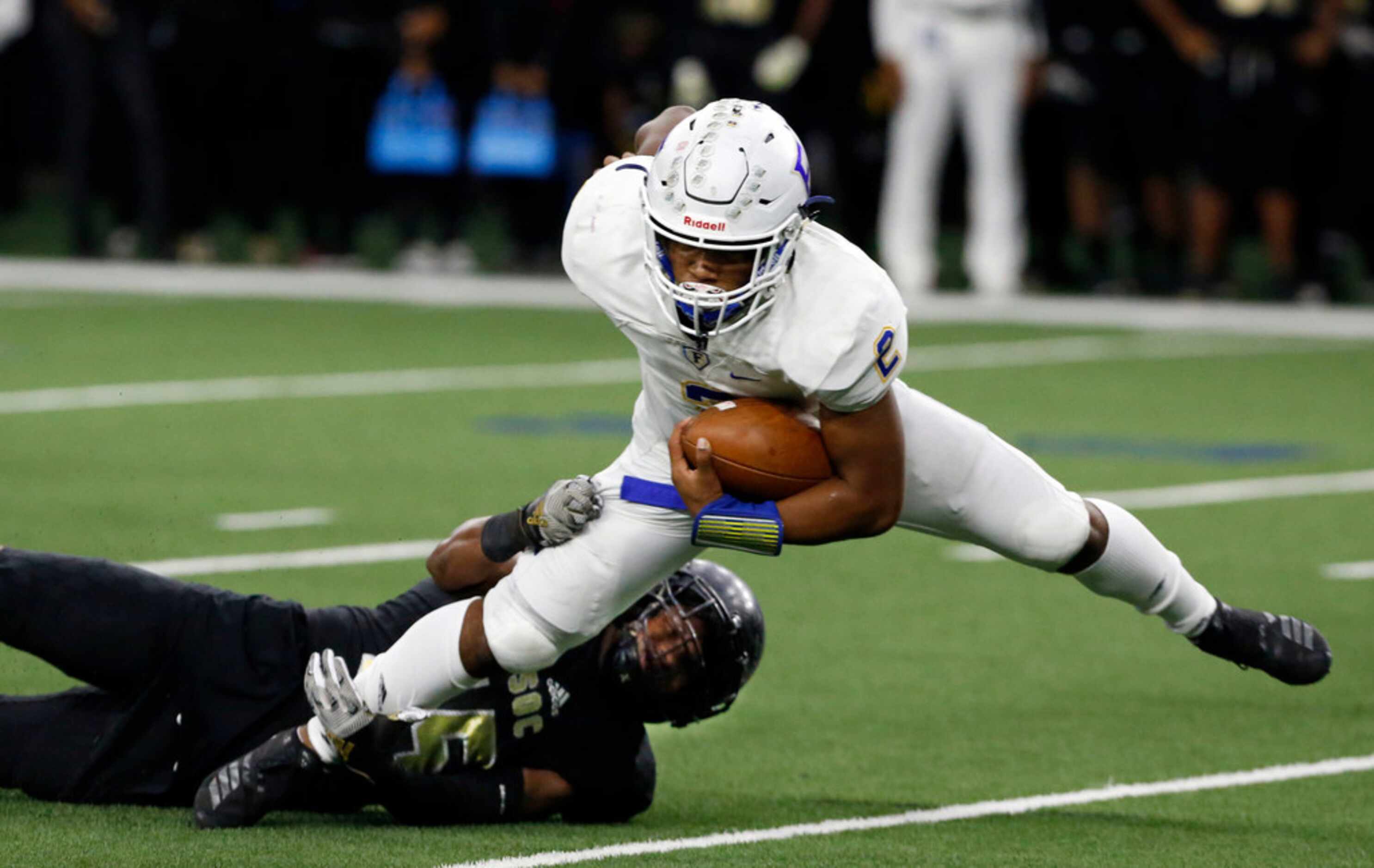 Frisco quarterback Caree' Green (2) is stretched out by South Oak Cliff defender Kimoni...