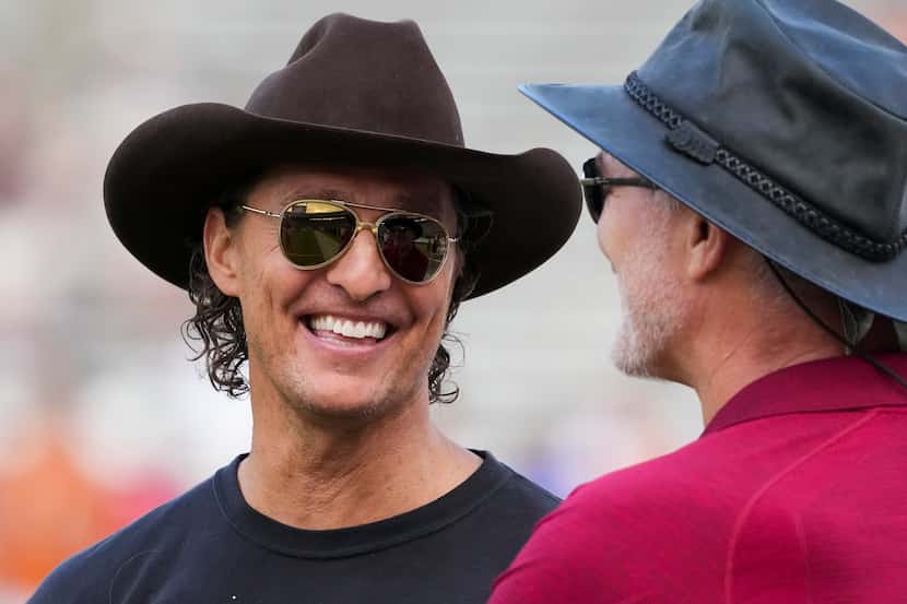 Actor Matthew McConaughey talks with former Oklahoma player Brian Bosworth before the annual...