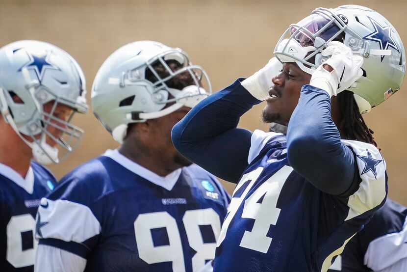 Dallas Cowboys defensive end Randy Gregory (94) adjusts his helmet during a practice at...