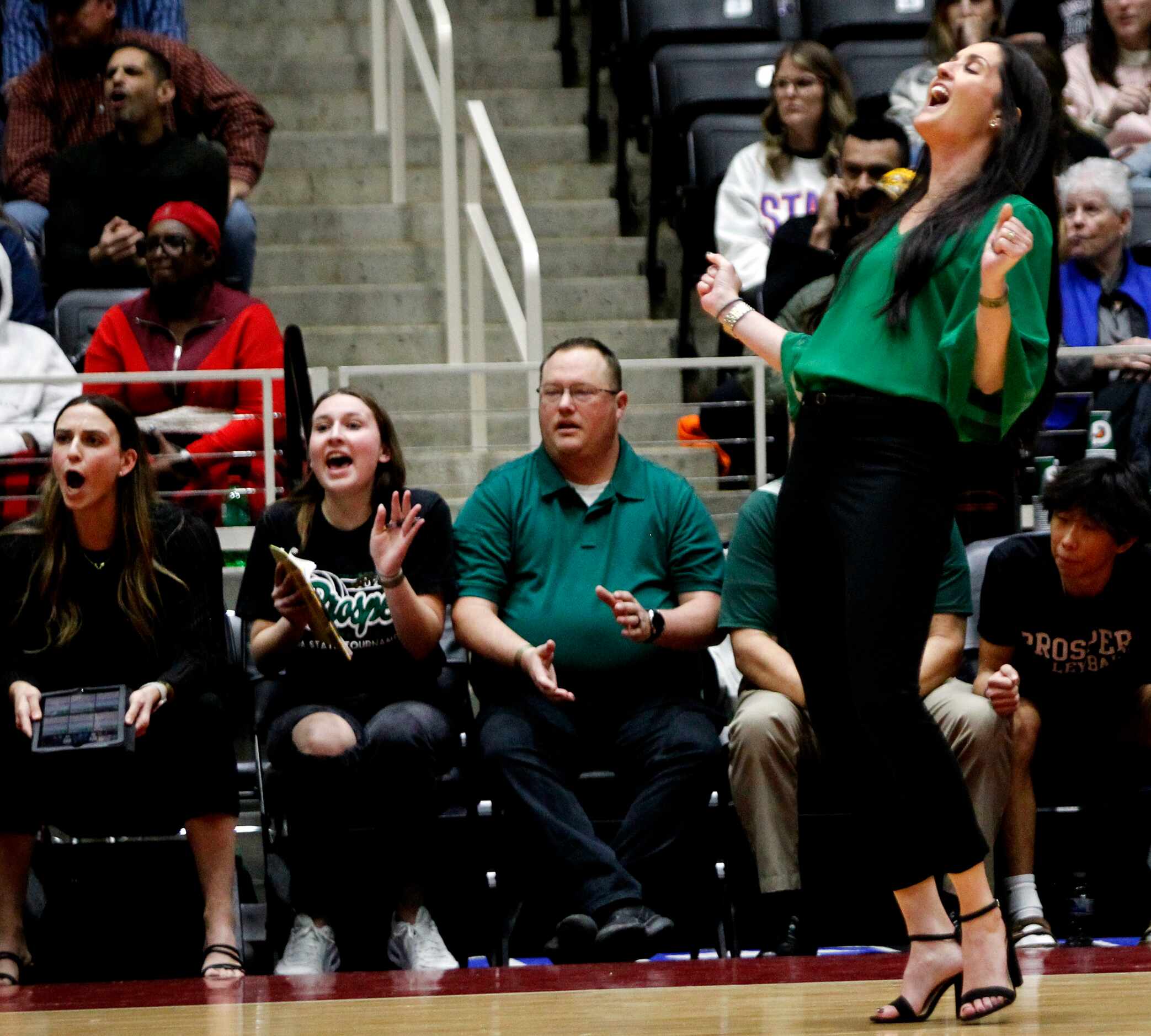 Prosper head coach Ashlee McCormick, right, reacts in front of the team bench after the...