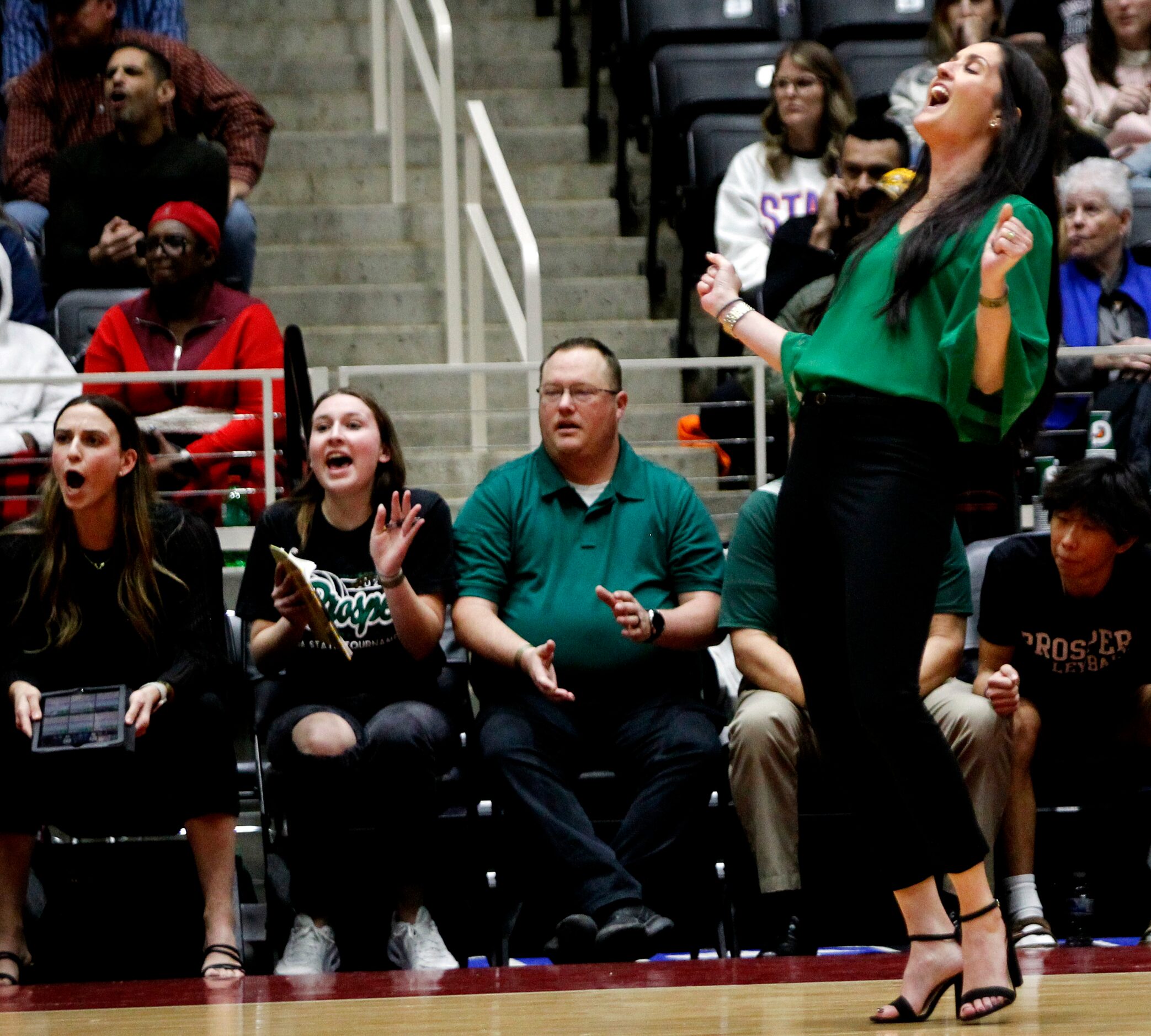 Prosper head coach Ashlee McCormick, right, reacts in front of the team bench after the...