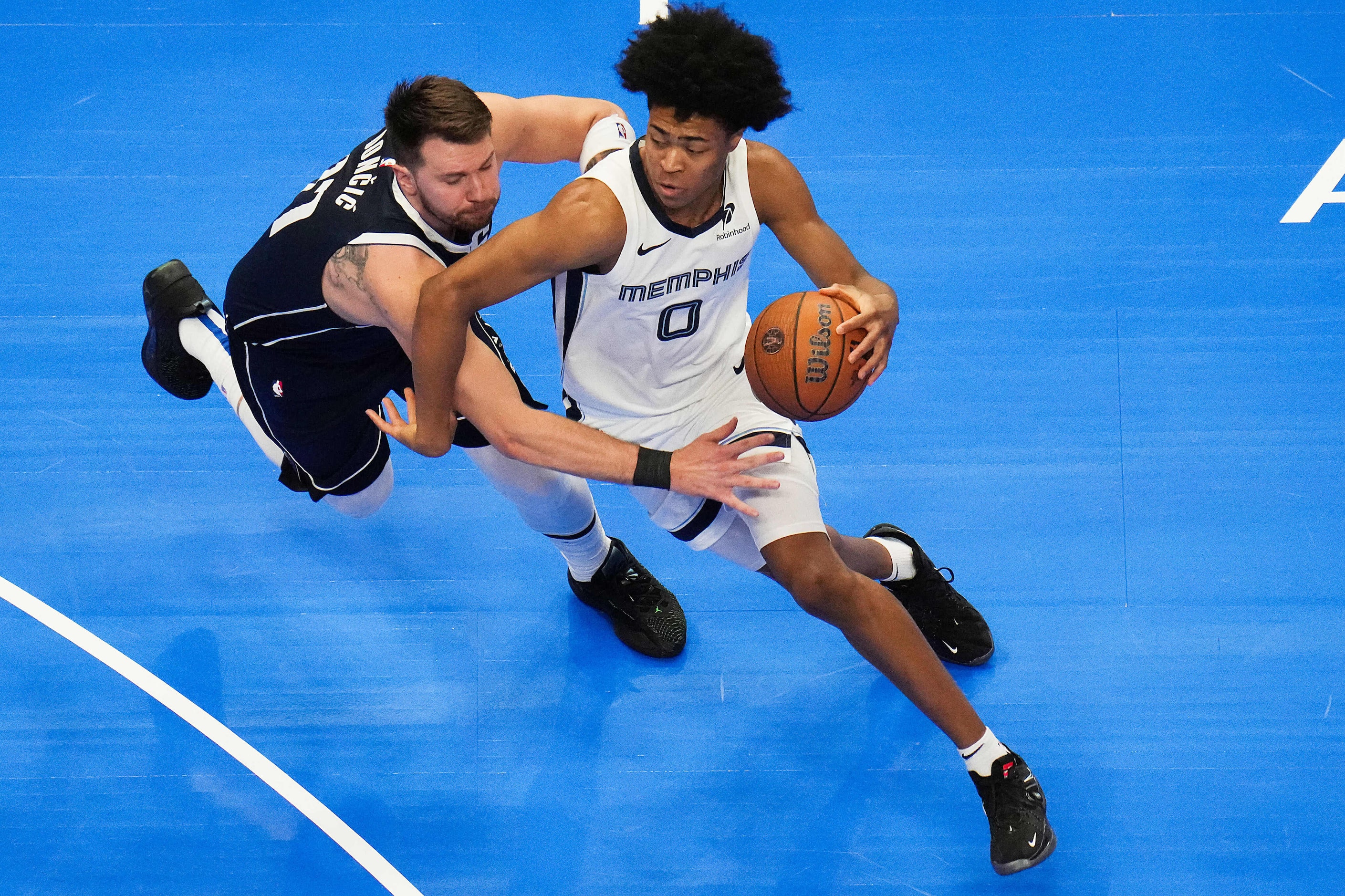 Memphis Grizzlies forward Jaylen Wells (0) gets past Dallas Mavericks guard Luka Doncic (77)...