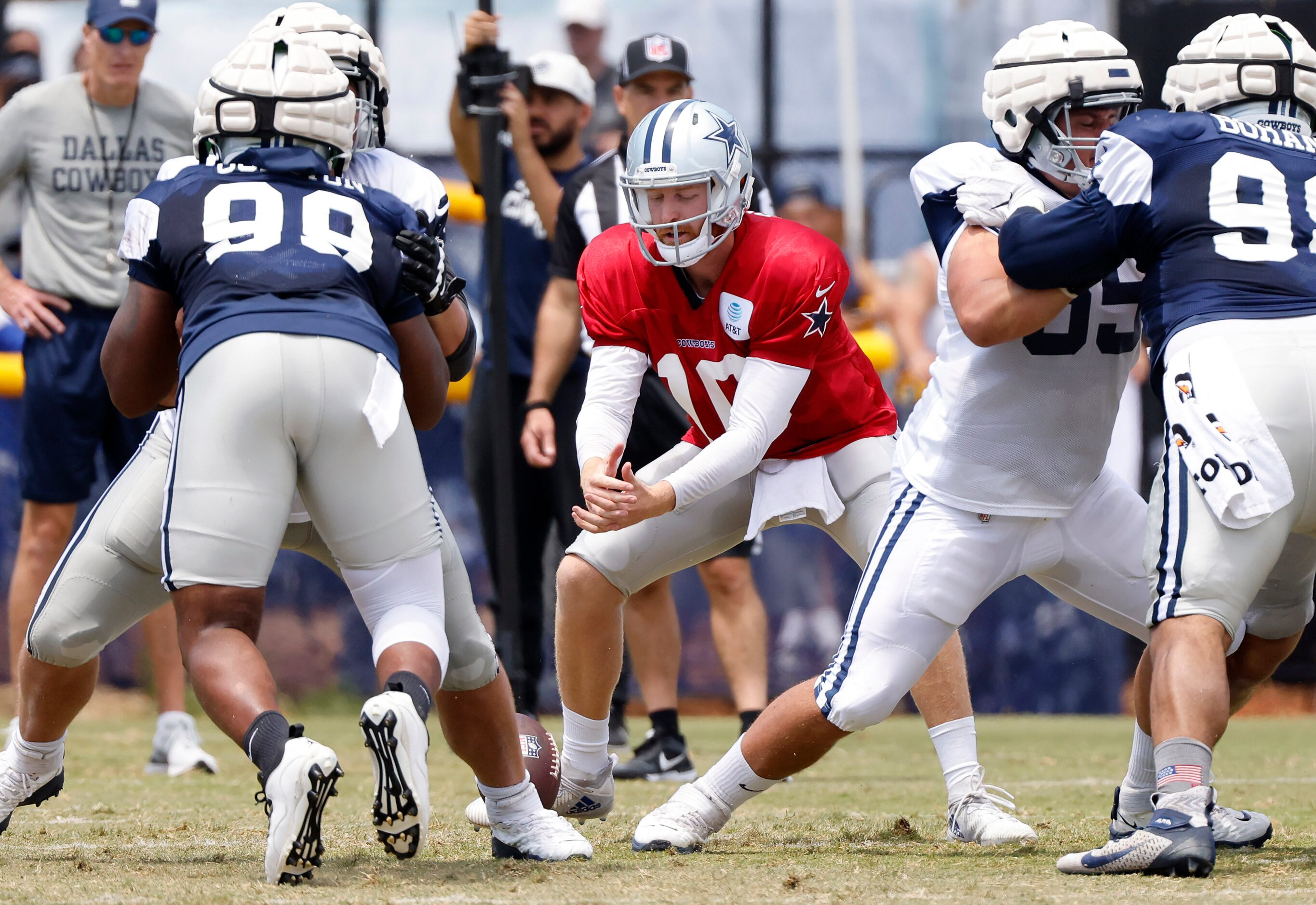 Dallas Cowboys quarterback Cooper Rush (10) drops a snap from center Tyler Biadasz (63)...